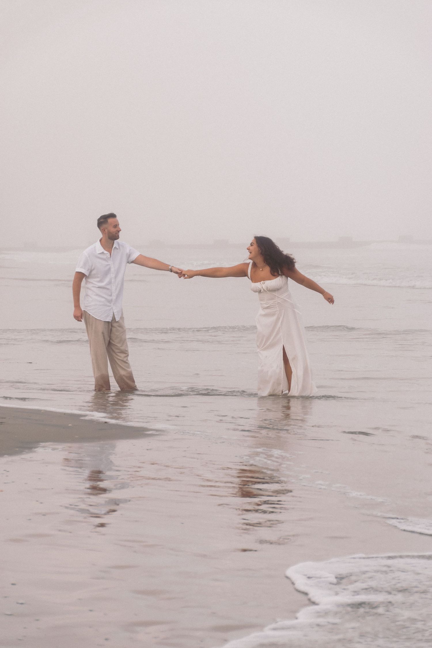 engagement photos south jersey beach photography, couple dancing and kissing during sunset under the moon and ocean.