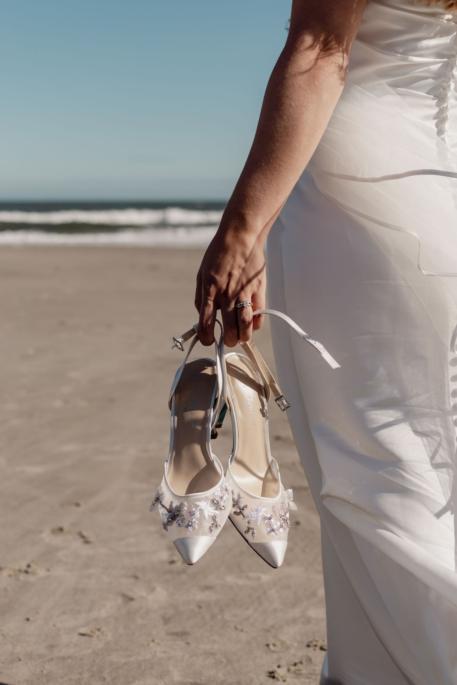 Bride and groom candid moment wedding day NJ. Ocean city NJ, beach portraits.
