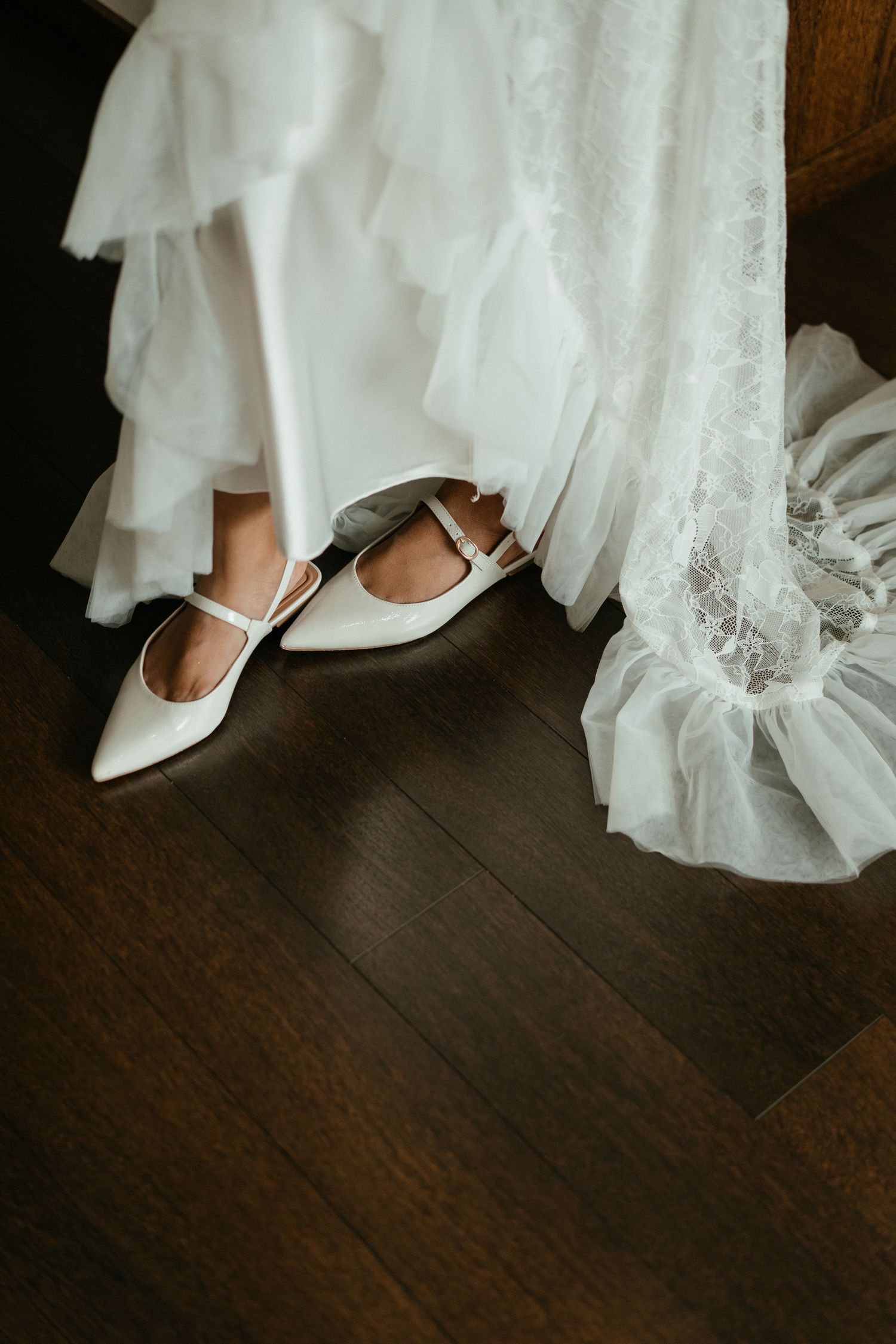 A detail shot of a bride's wedding dress and shoes during morning preparations for a beach wedding near Porto, Portugal