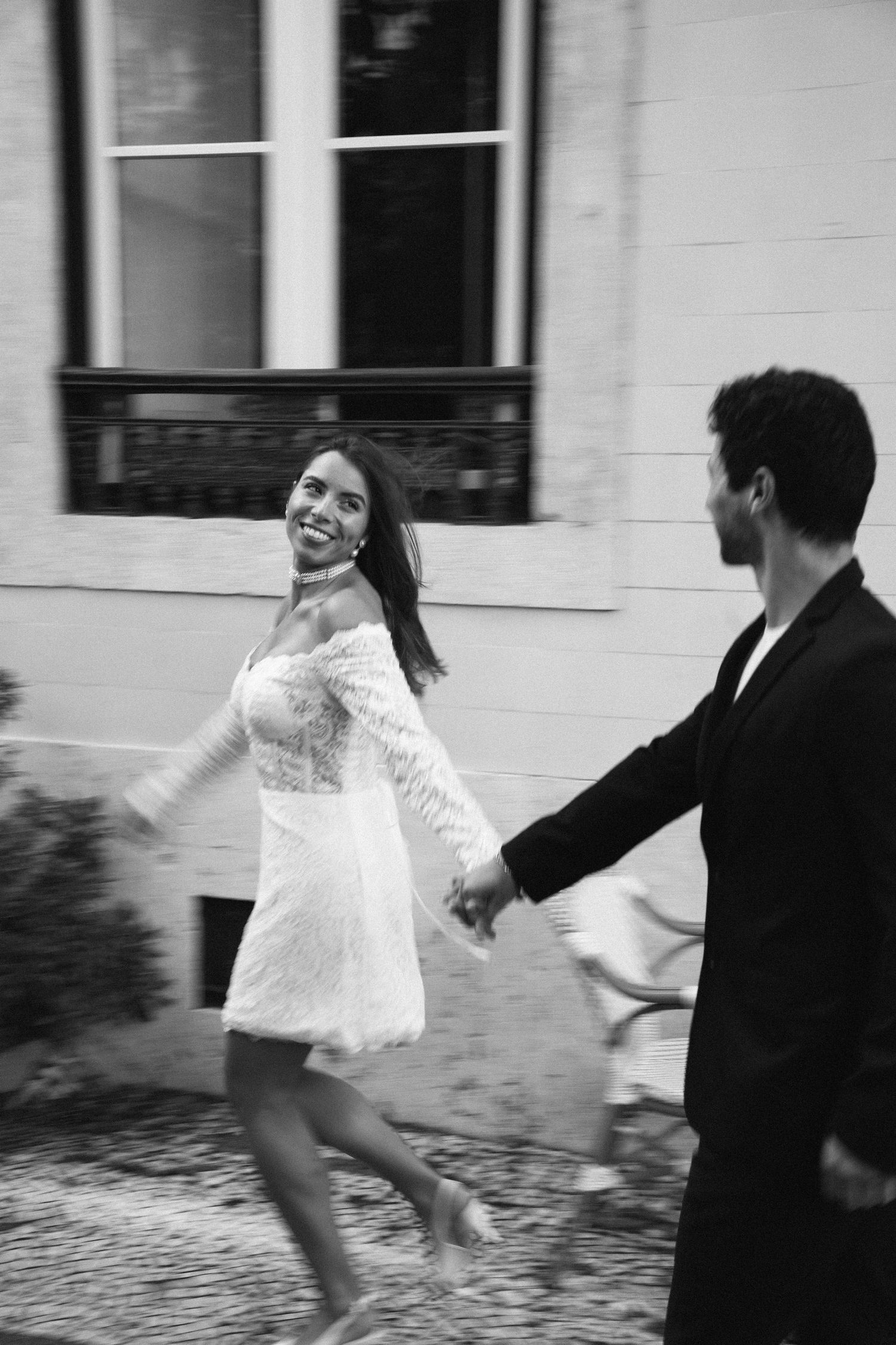 A couple running together joyfully outside during their elopement at Palácio do Visconde in Portugal