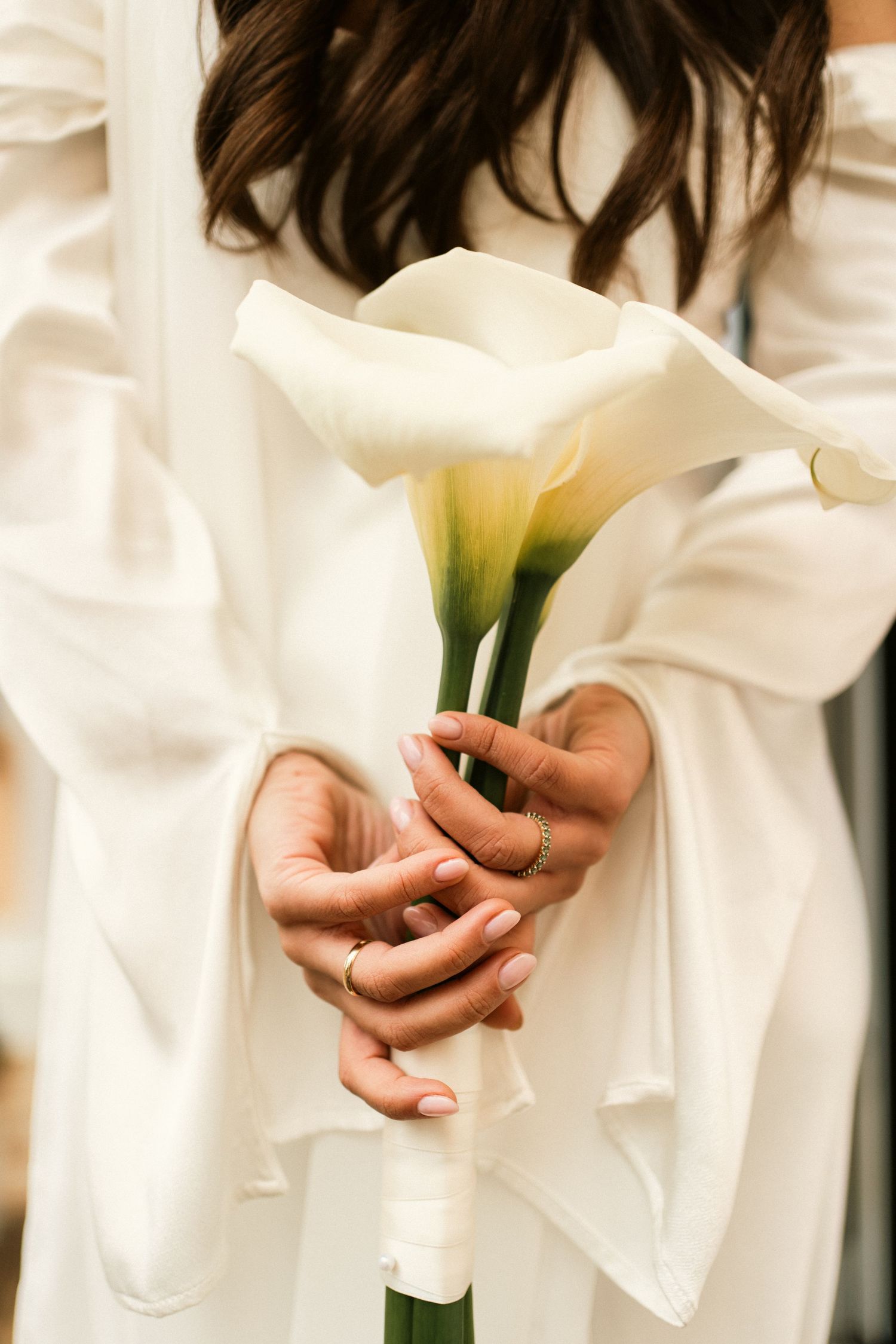 A bride holding a white calla lily bouquet in her wedding dress during an elopement in Sintra, Portugal