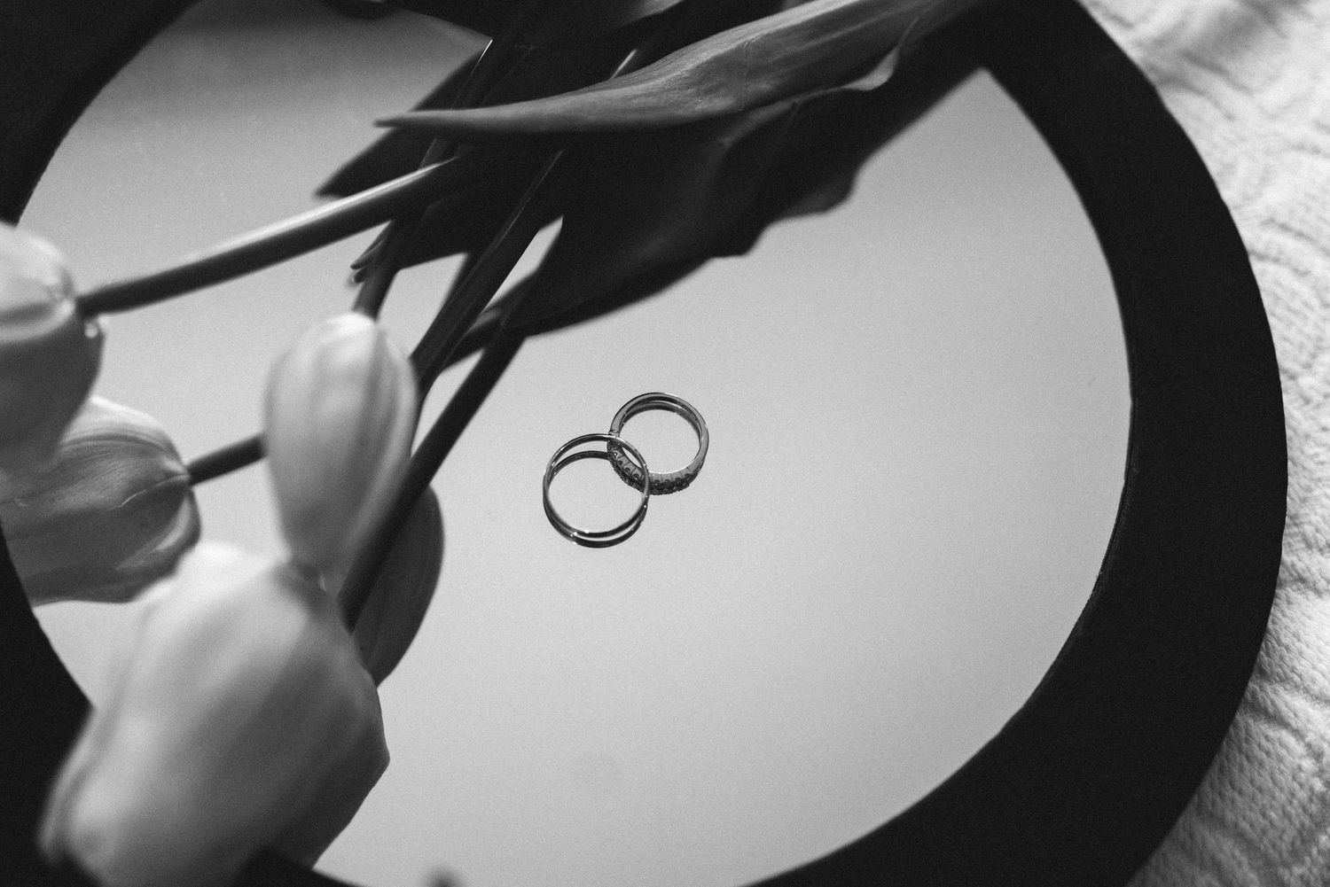 A black and white close-up of two wedding rings during a wedding ceremony in Portugal