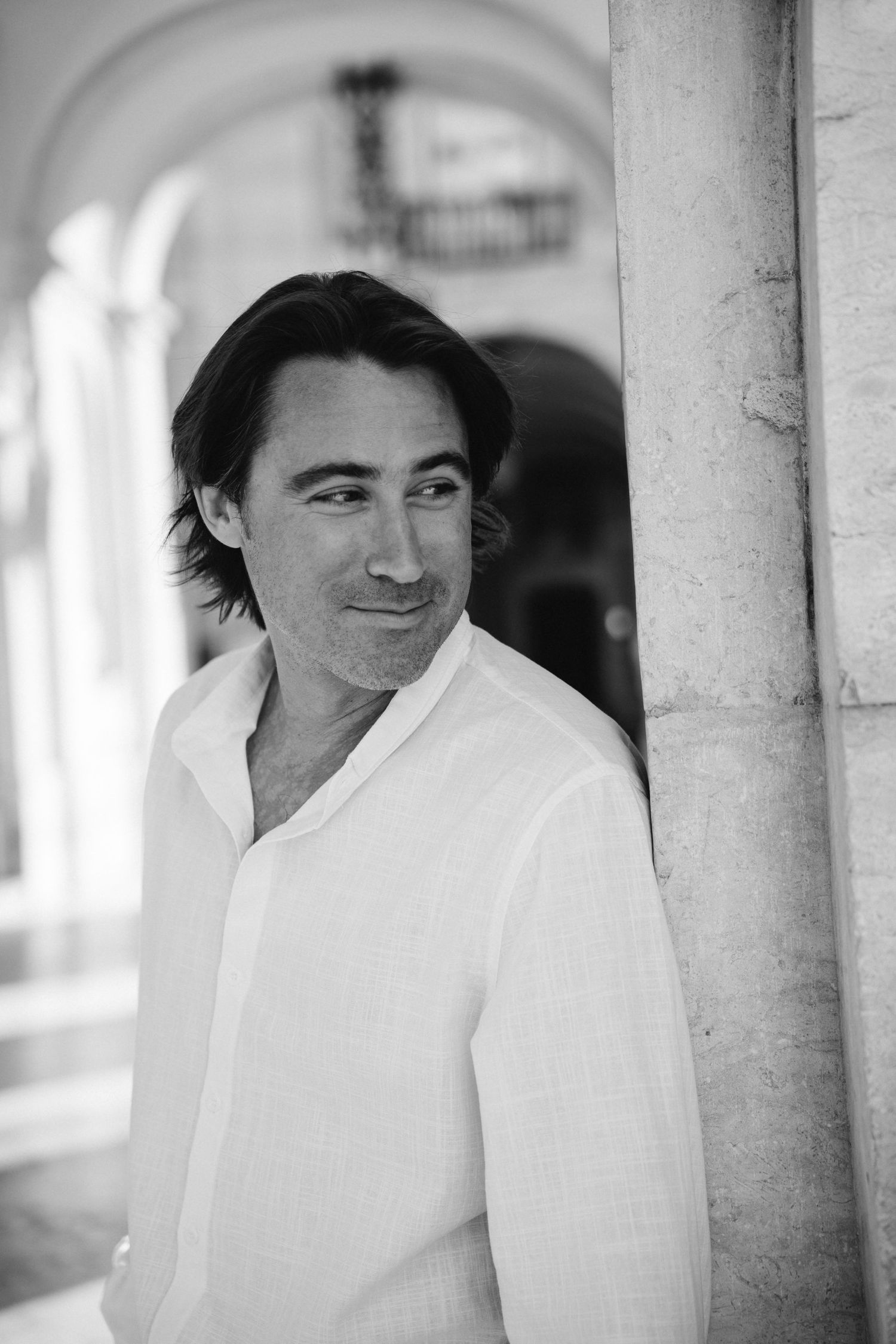 A black and white portrait of a man in Lisbon during a couples photography session in Portugal