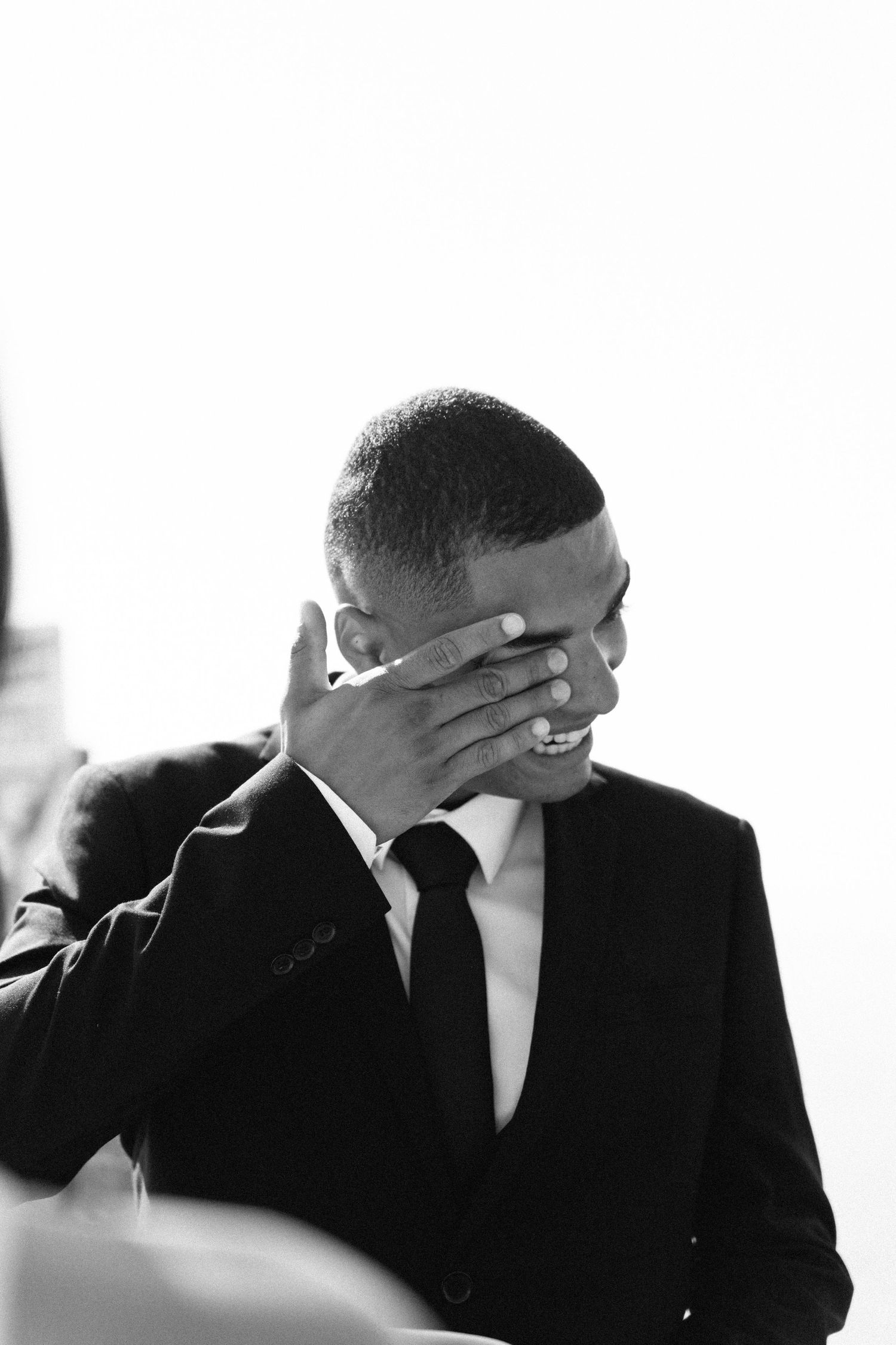 A candid black and white portrait of a groom overcome with emotion during an elopement in Portugal
