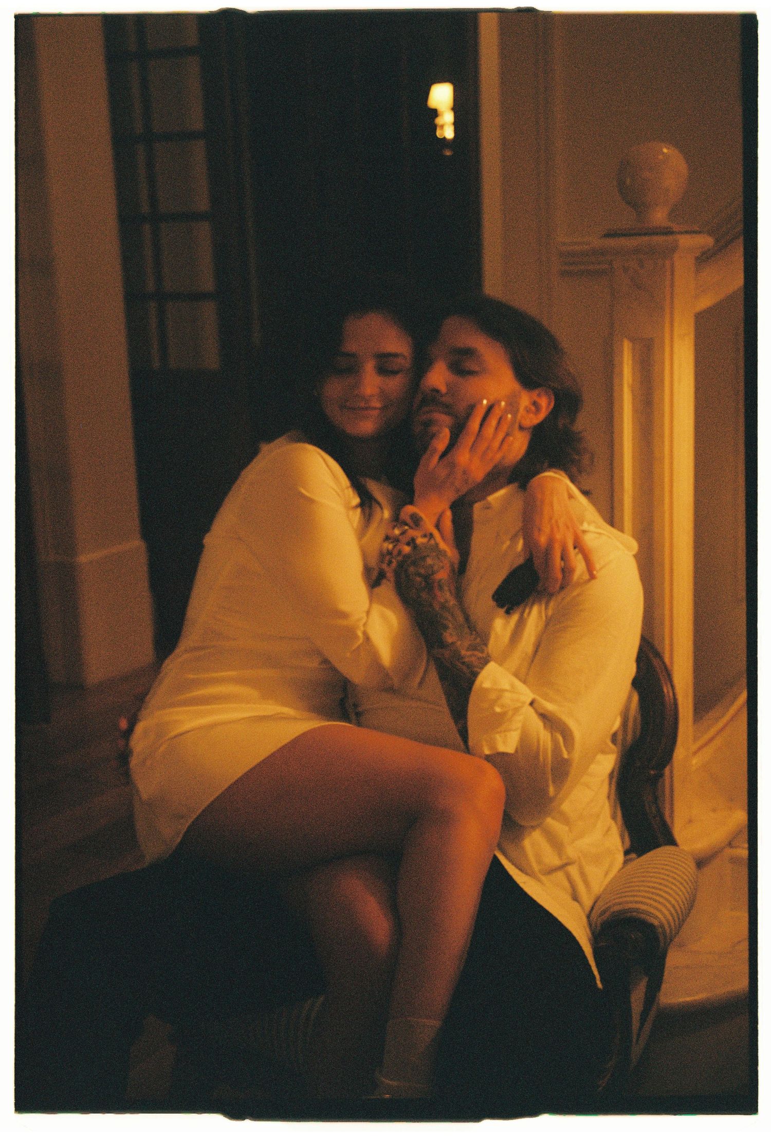 A couple sharing a tender moment in a warmly vintage hotel room, elopement photography in Portugal