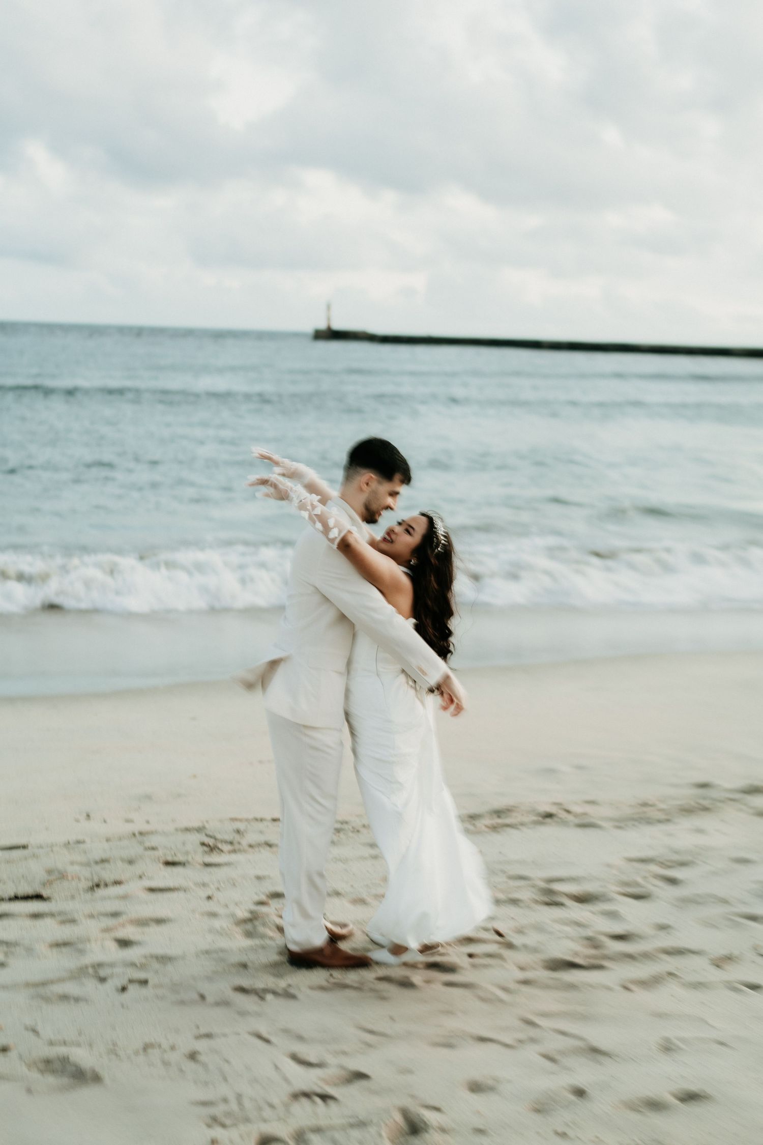 Bride and groom on Atlantic beach during outdoor wedding ceremony near Porto Portugal