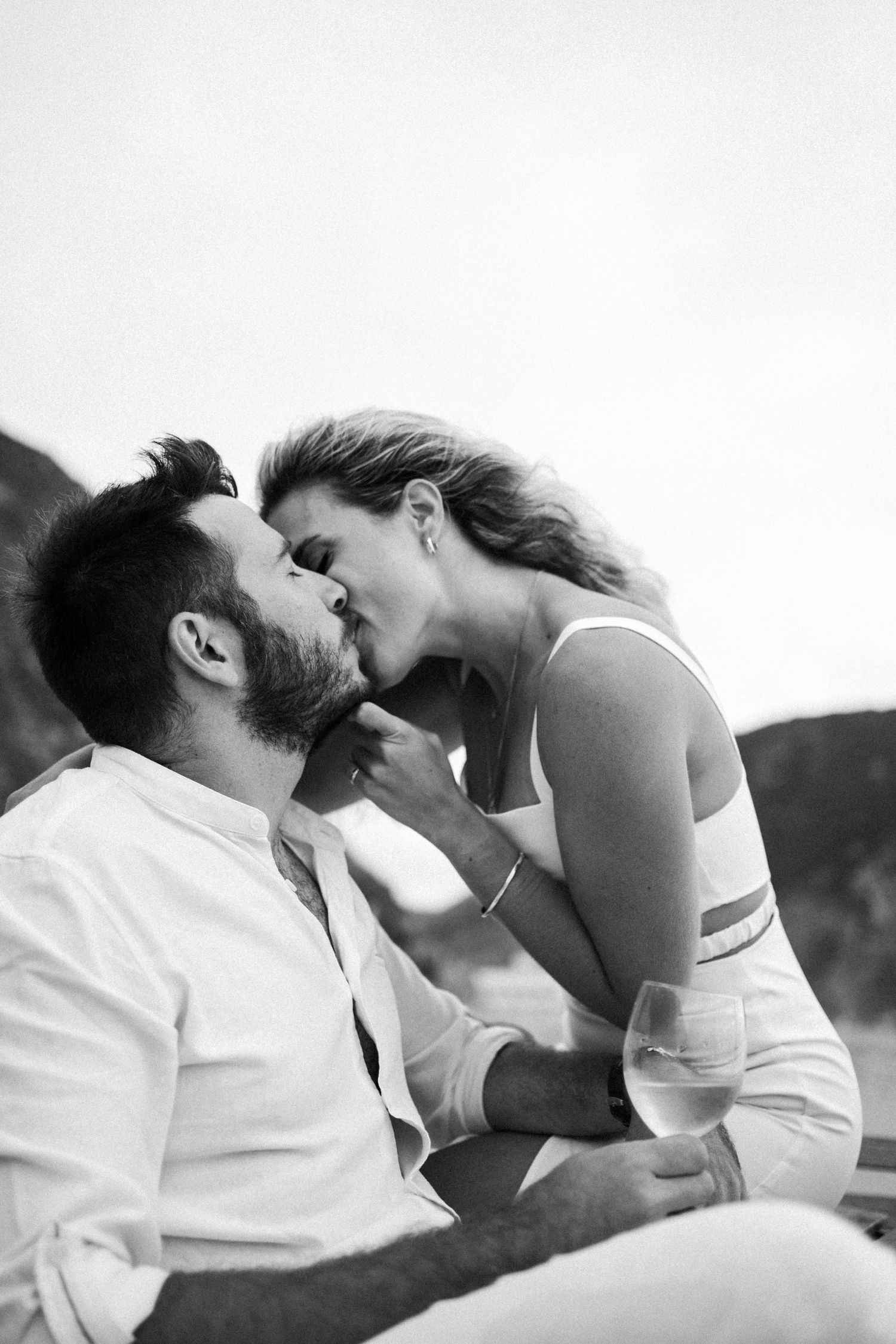 A couple sharing a tender kiss on Praia da Adraga during their wedding portraits session in Portugal