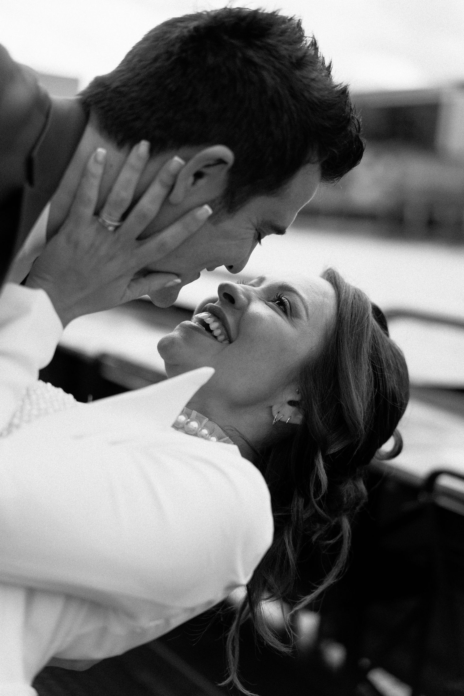 A black and white close-up of a couple sharing a tender moment during wedding portrait session in Portugal
