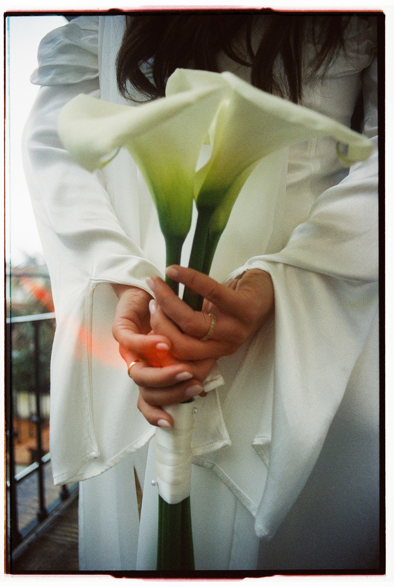 A film photograph of a bride holding a white calla lily bouquet during her elopement at Lawrence's Hotel in Sintra, Portugal
