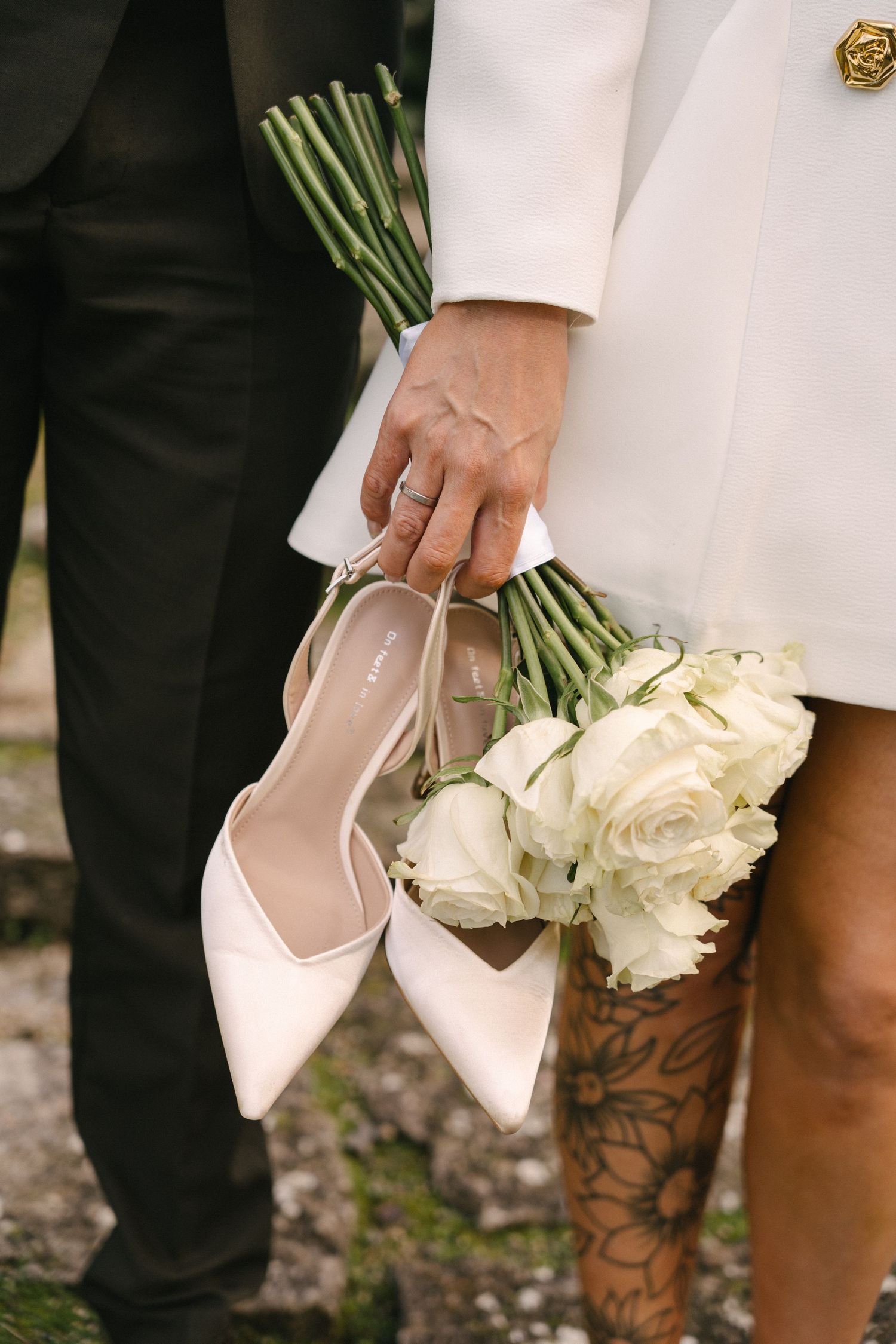 A bride holding a white rose bouquet during an elopement in Lisbon, Portugal