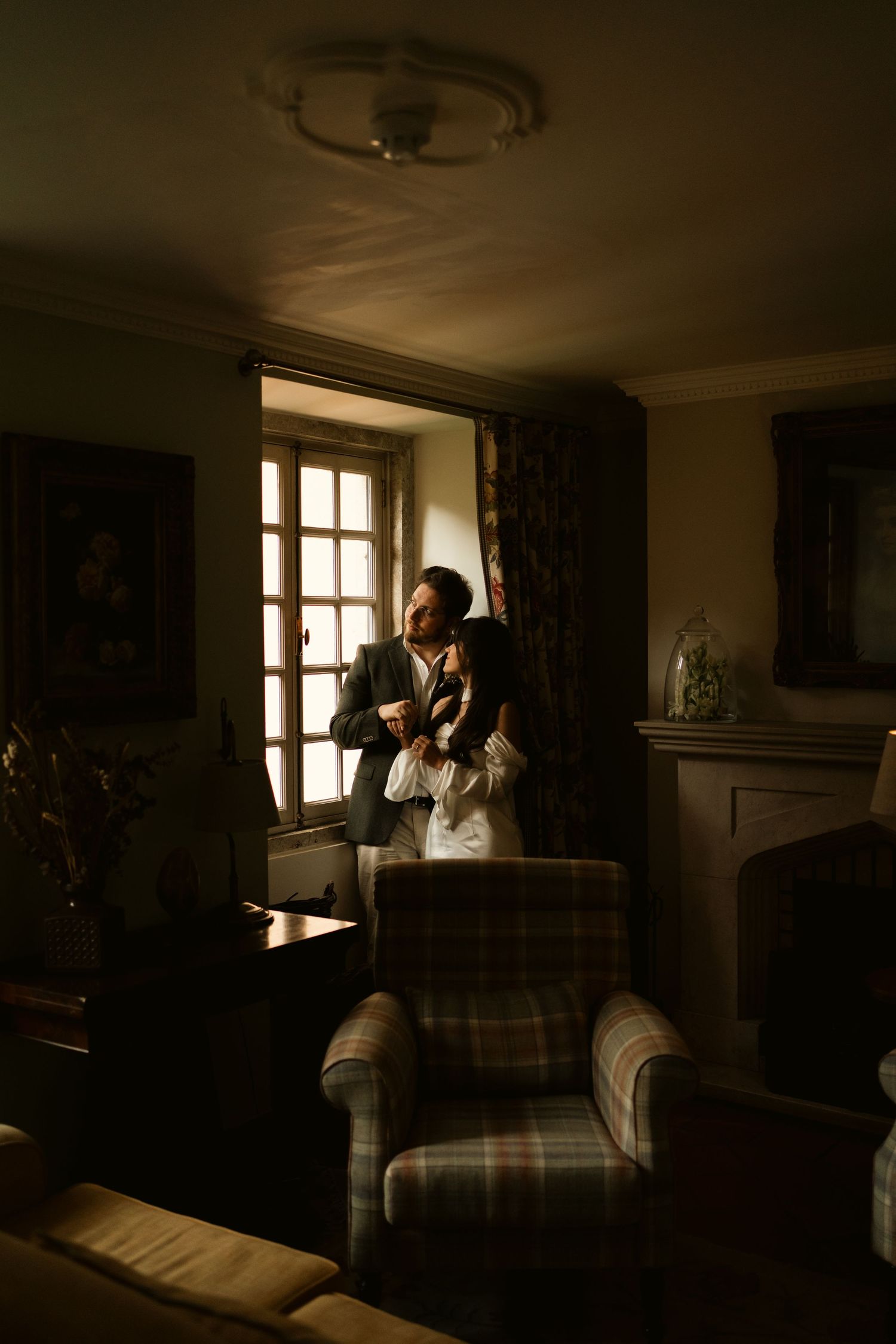 Couple by window in a vintage hotel room, elopement  photography at Lawrence's Hotel Sintra