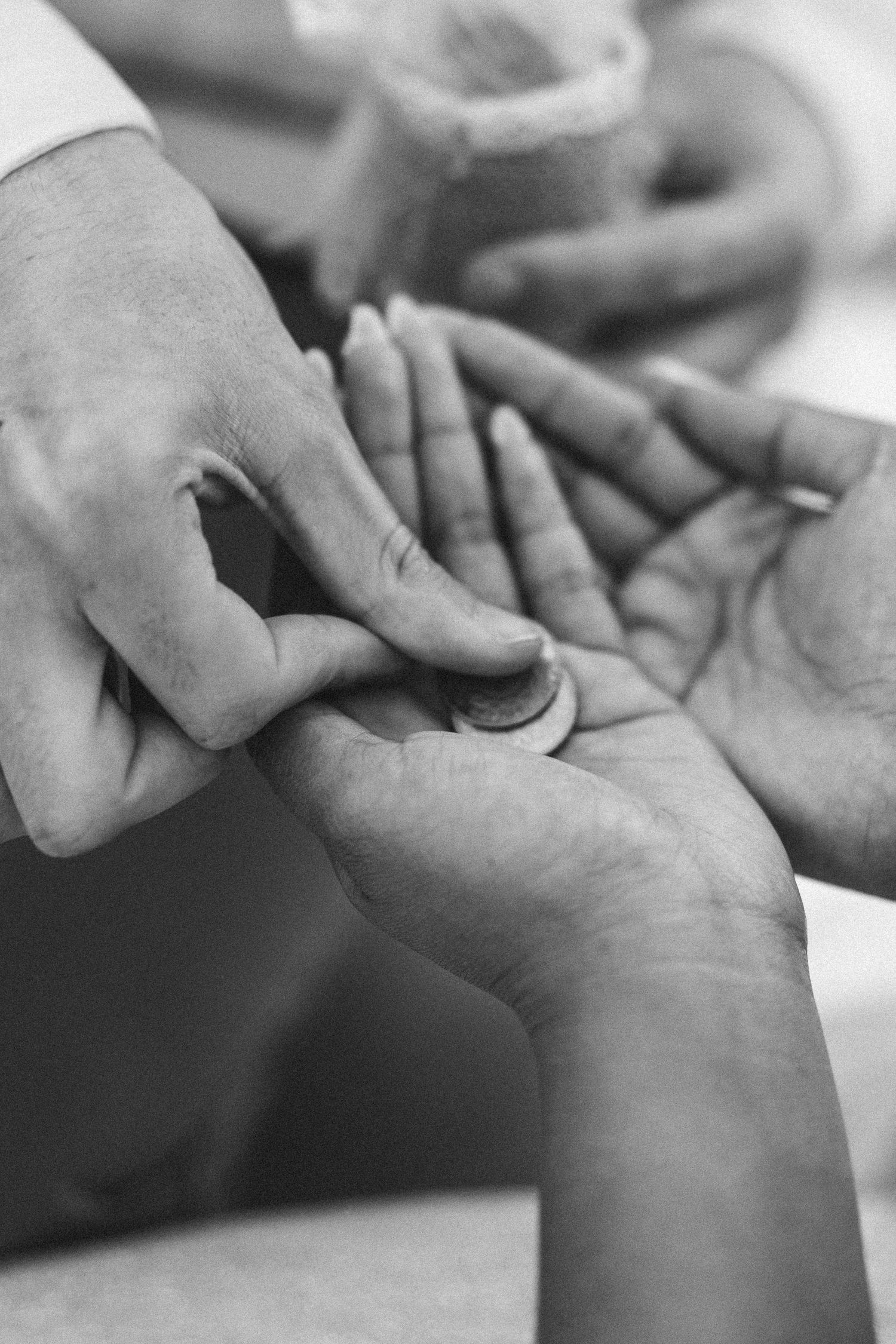 Close-up of couple's hands during Filipino Portuguese wedding ceremony, documentary wedding photography Portugal