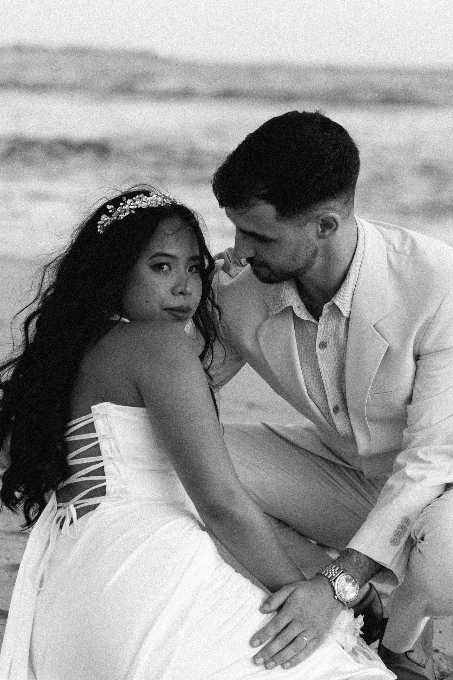 A bride and groom embracing on the beach at Praia da Azurara during their wedding portraits session near Porto, Portugal