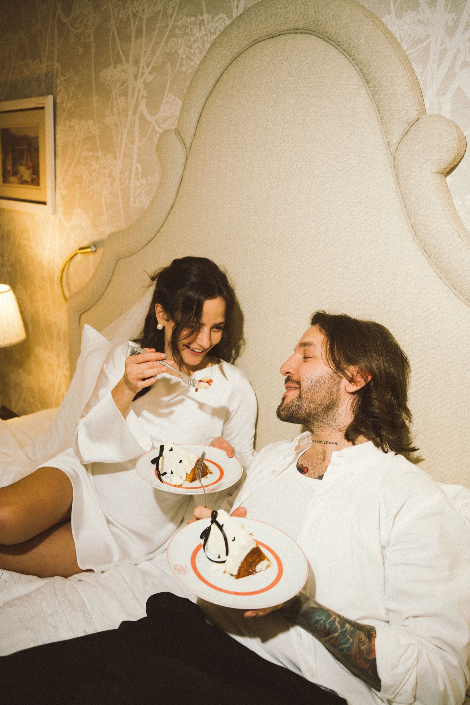Couple eating wedding cake in bed after intimate elopement, Estoril Vintage Hotel near Lisbon Portugal