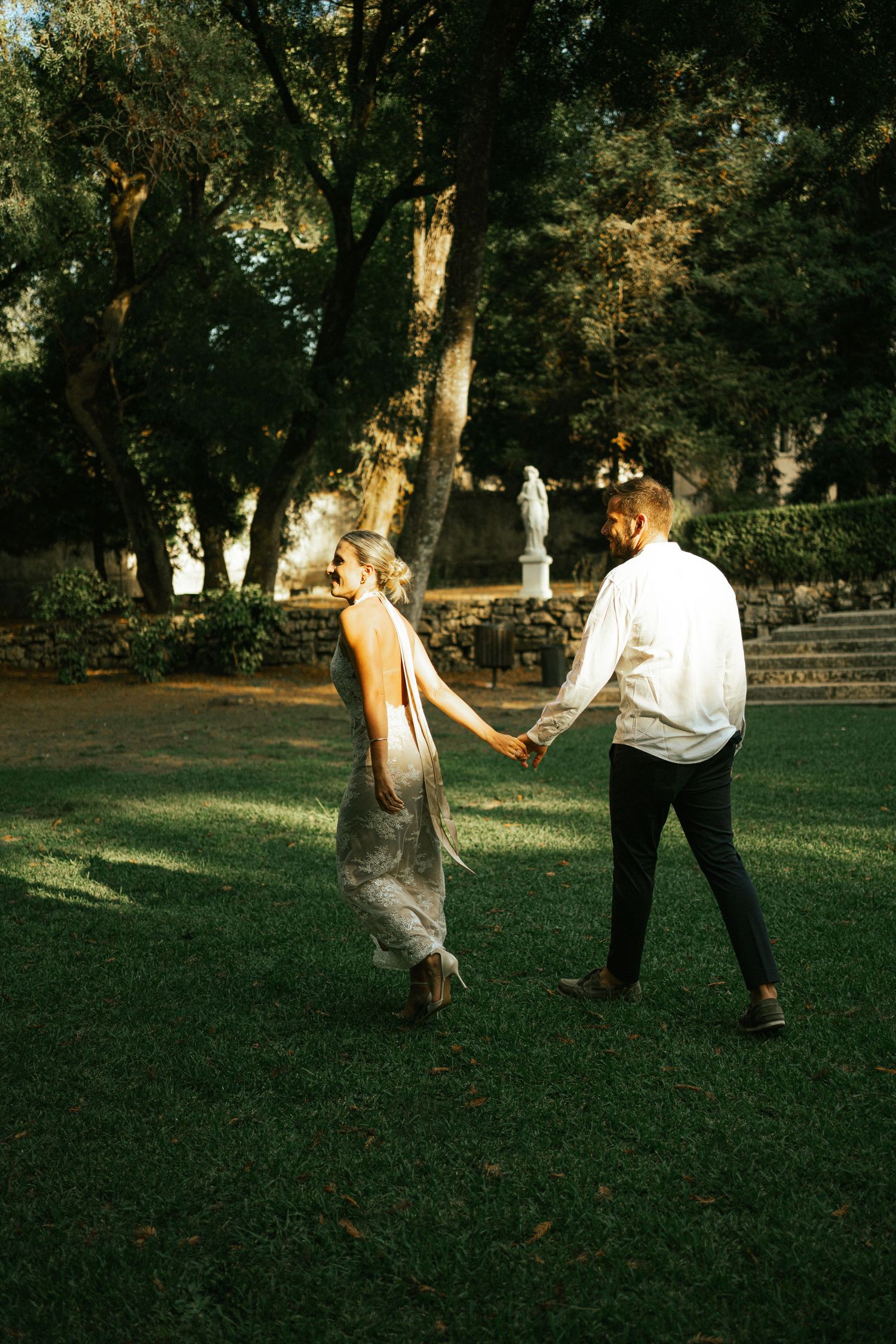A couple dancing together on a sunny garden lawn during their elopement in Portugal
