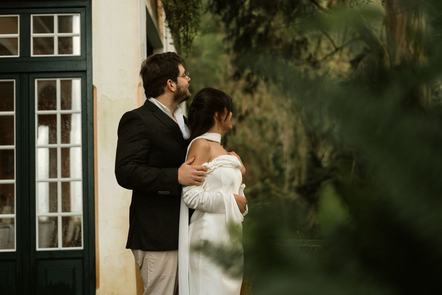 A bride and groom embracing in front of Lawrence's Hotel during their elopement in Sintra, Portugal