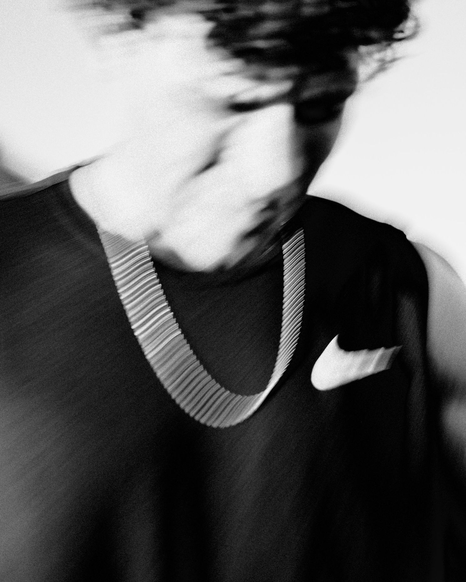 Abstract black and white portrait with focus on striped collar detail.