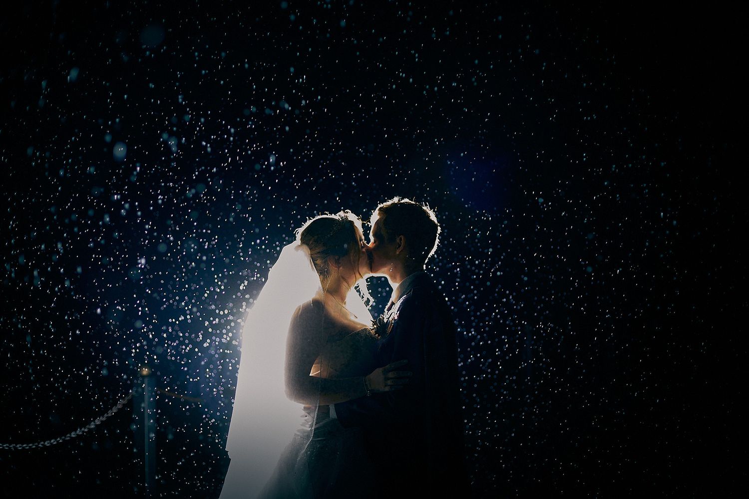 Creative night wedding photography in New Zealand with rain backlight effect