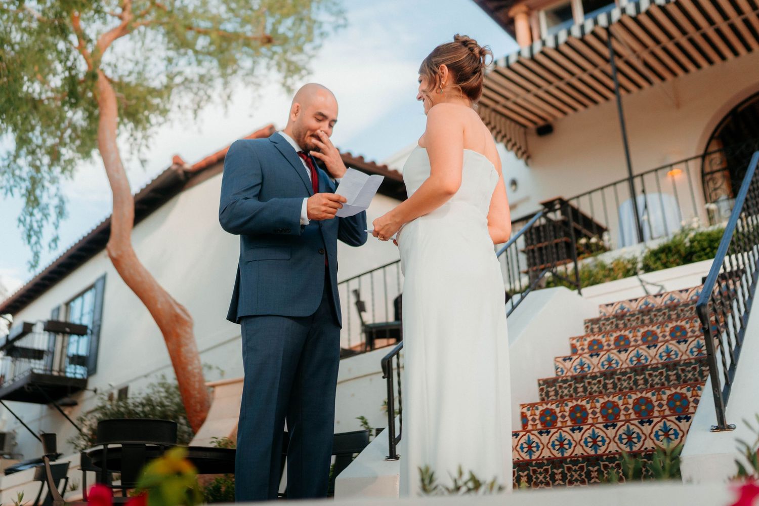Groom reads heartfelt vows to bride during outdoor wedding ceremony at a Spanish villa.