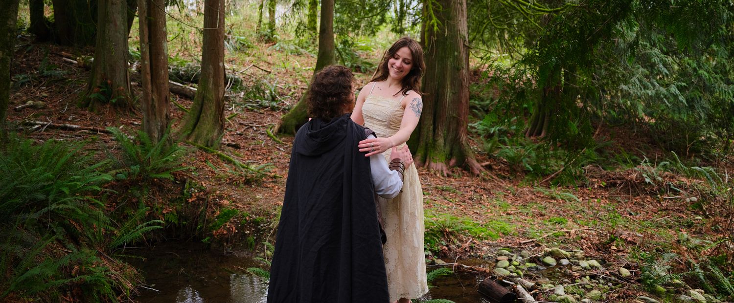 A couple preparing for a photoshoot in a Washington State forest. Photo by N&D Wedding Photography and Film