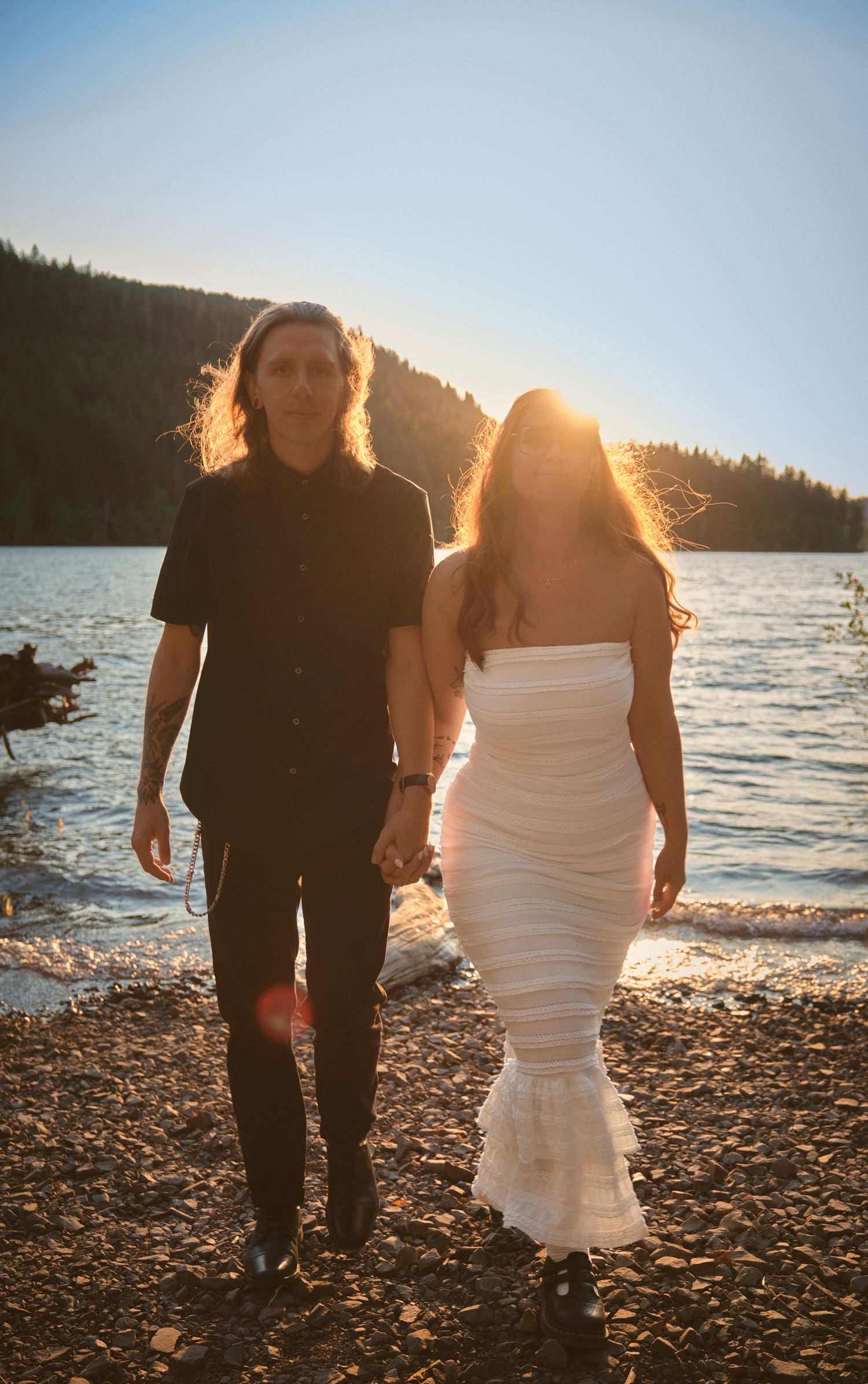 A couple walking and holding hands by Spada Lake in Snohomish County. Photo by N&D Wedding Photography and Film