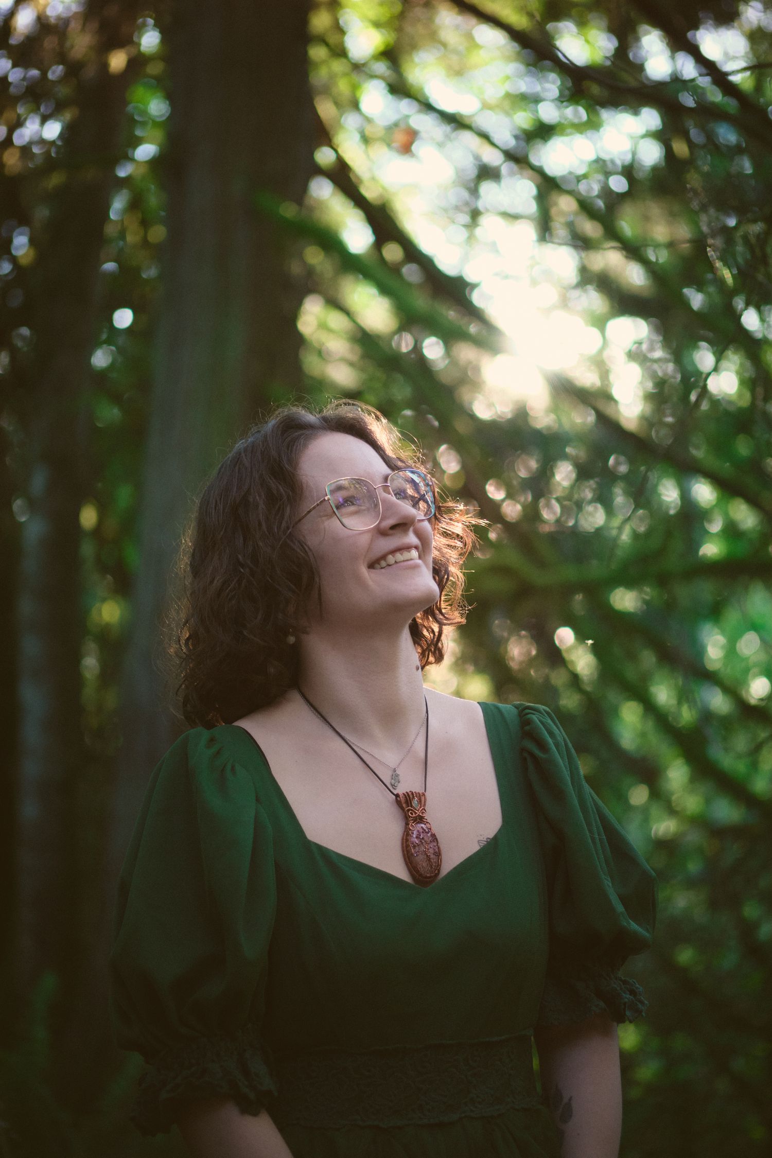 A photo of Foggé Crystal Co owner Miranda smiling in a Snohomish County, Washington State forest. Photo by N&D Wedding Photography and Film