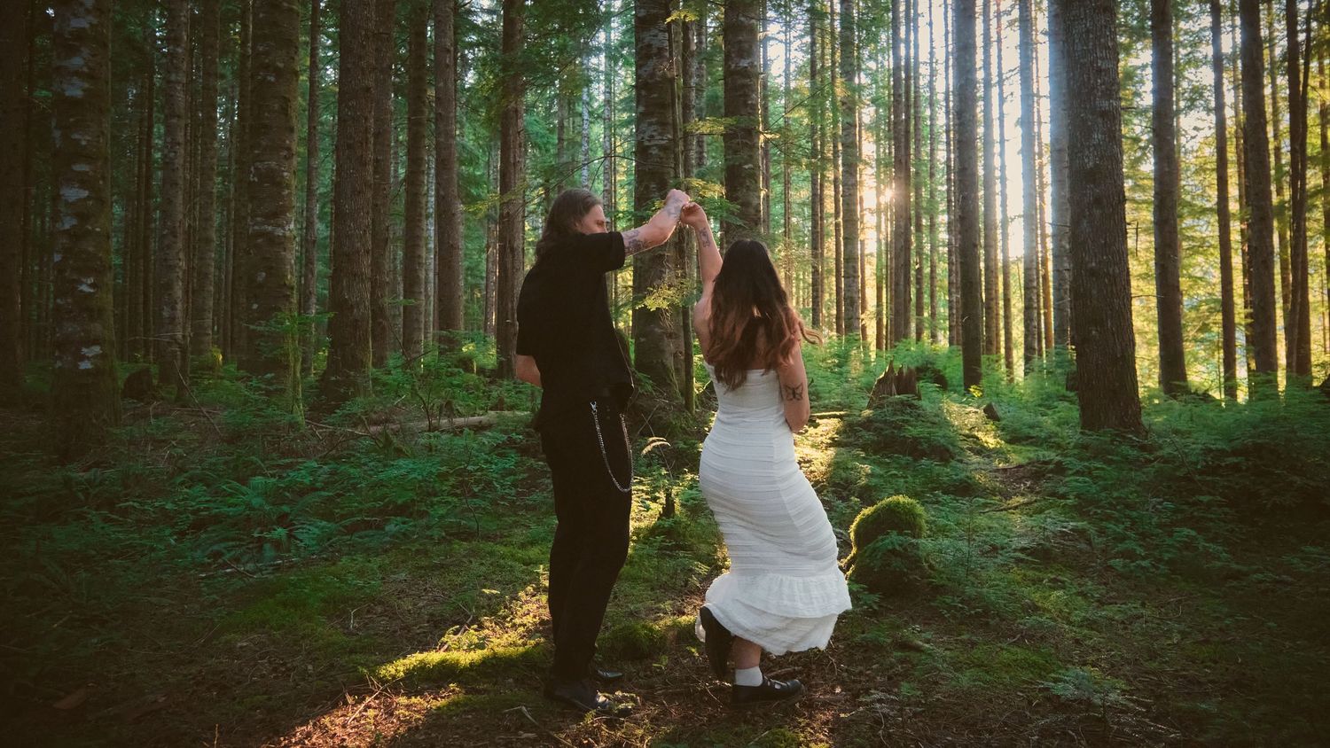 Fiancés dancing in a forest in Washington State. Photo by N&D Wedding Photography and Film