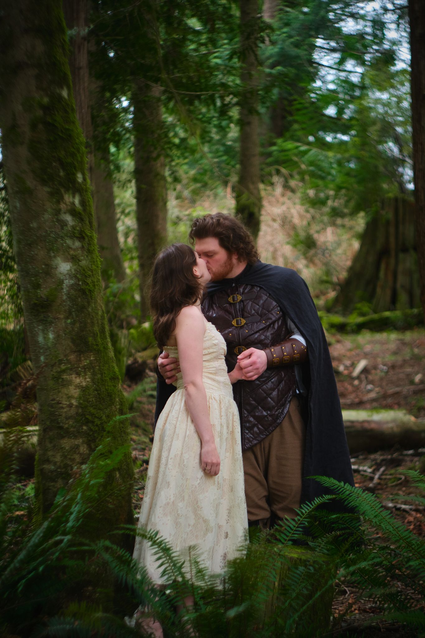 A couple kissing in a forest in Washington State. Photo by N&D Wedding Photography and Film