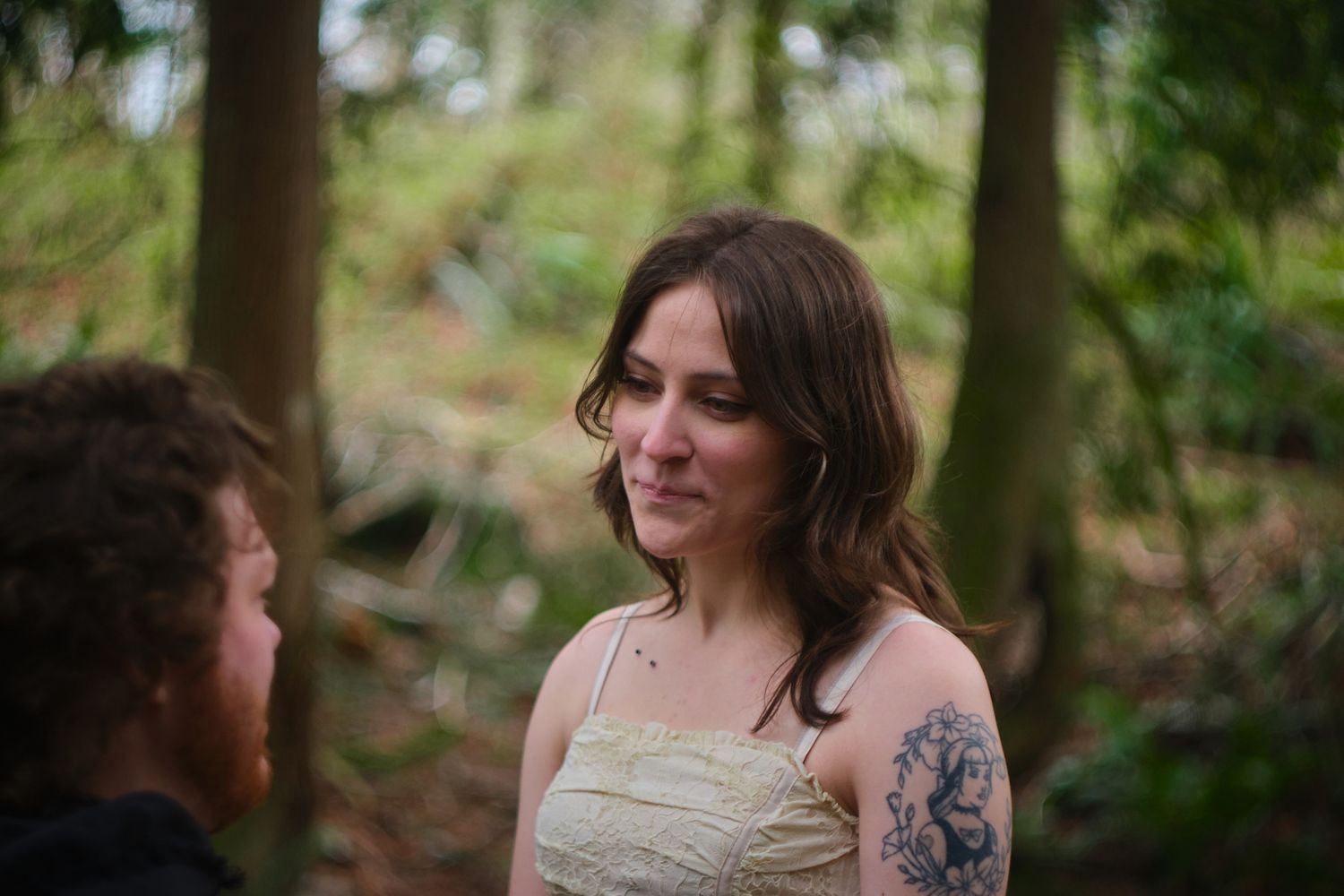 A couple telling stories to each other in a Washington State forest. Photo by N&D Wedding Photography and Film