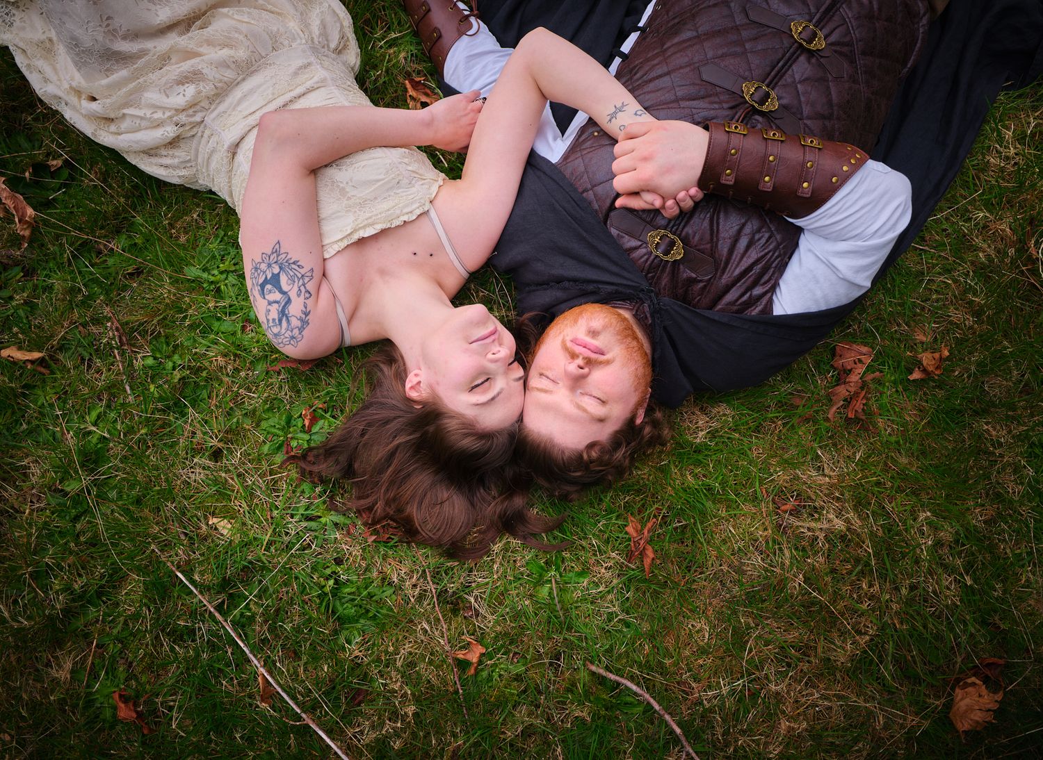 A couple laying down and embracing each other with their heads touching, taken in WA, State. Photo by N&D Wedding Photography and Film