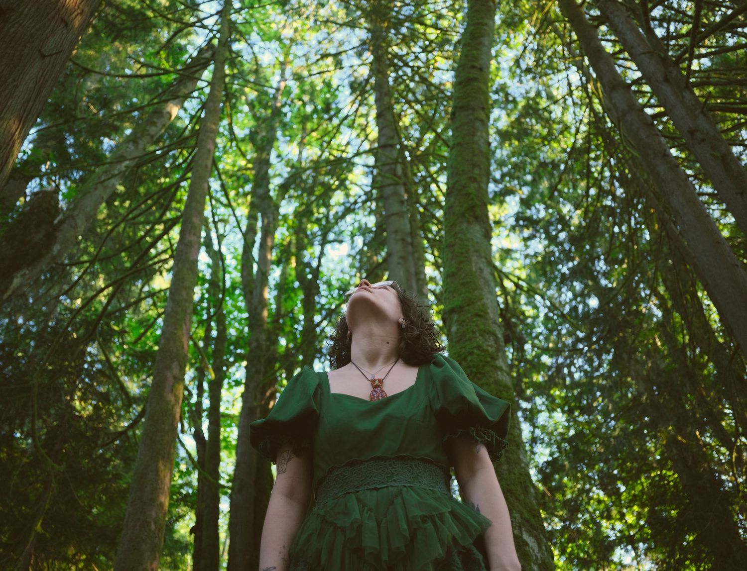 Foggé Crystal Company owner Miranda looking up in a Snohomish County, Washington State forest. Photo by N&D Wedding Photography and Film