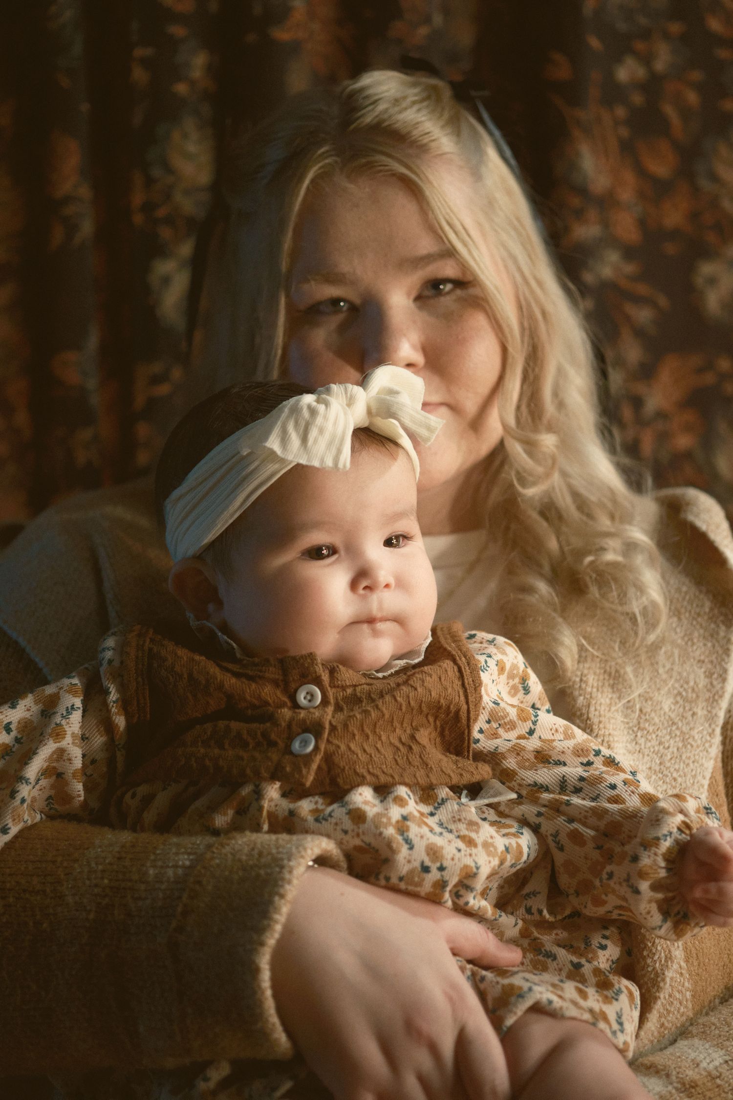 A mother holding her baby stoically, taken in Snohomish County, Washington State. Photo by N&D Wedding Photography and Film