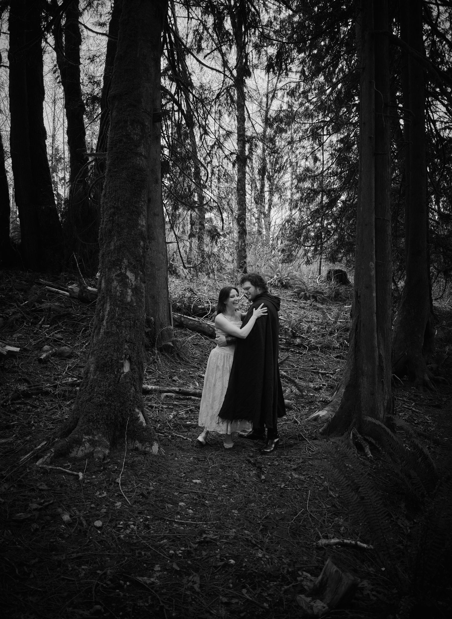 A couple embracing one another in a Washington State forest. Photo by N&D Wedding Photography and Film