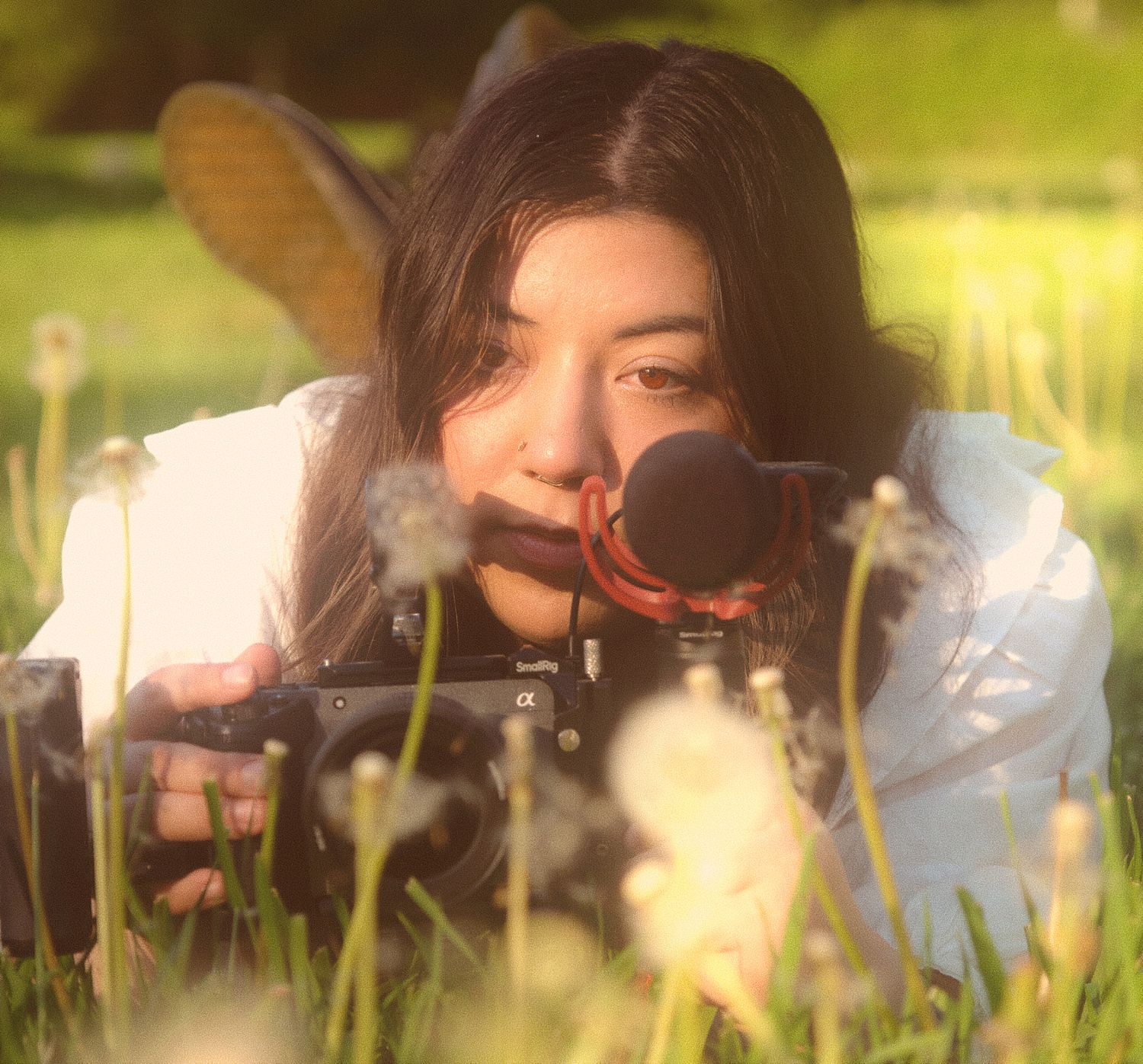Nicole the videographer for N&D Wedding Photography and Film filming with her FX30 cinema camera in a grove in Washington State.