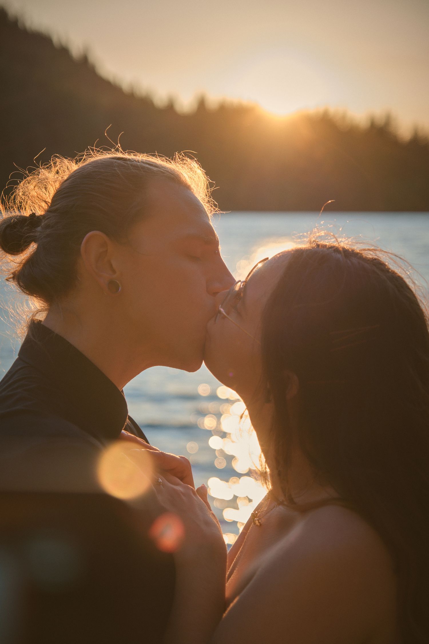 An engaged couple kissing by Spada Lake in Snohomish County. Photo by N&D Wedding Photography and Film