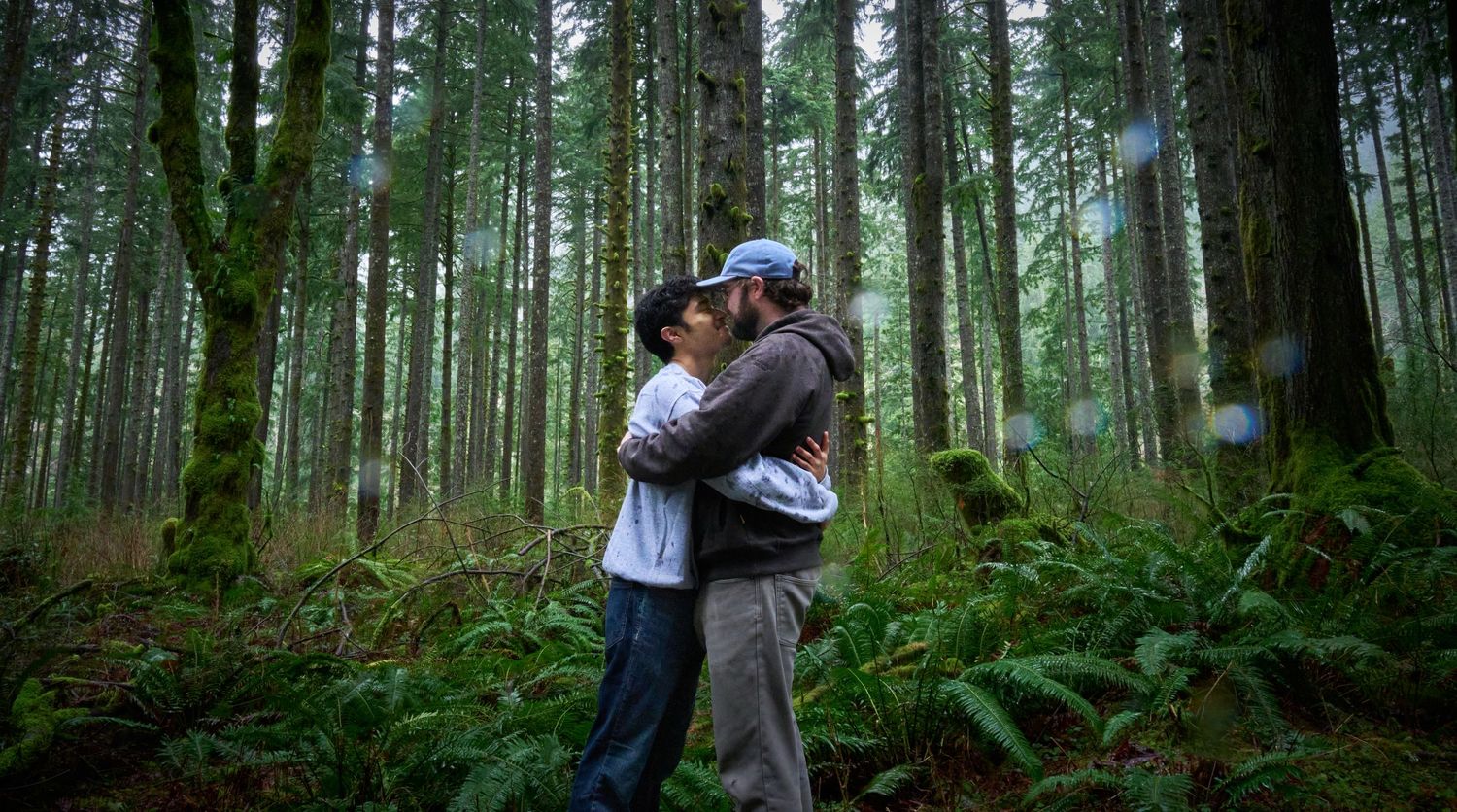 A couple embracing in a Washington State forest in the rain. Photo by N&D Wedding Photography and Film