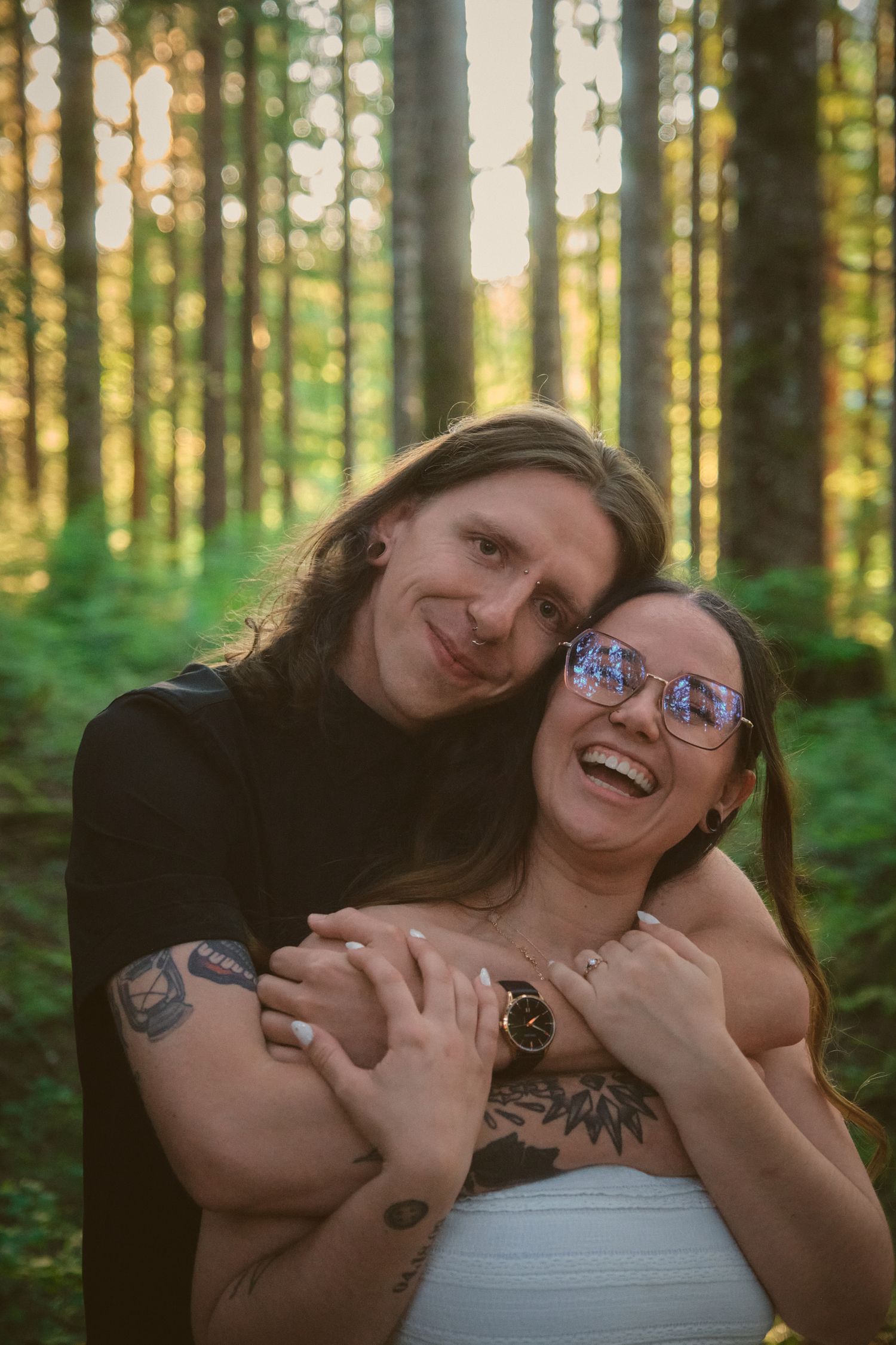 Fiancés embracing each other in a forest in Washington State. Photo by N&D Wedding Photography and Film