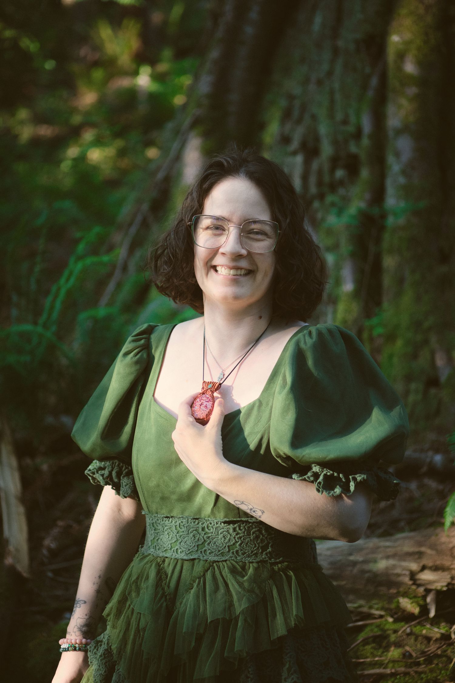 A photo of Foggé Crystal Company owner Miranda laughing in a Washington State forest. Photo by N&D Wedding Photography and Film
