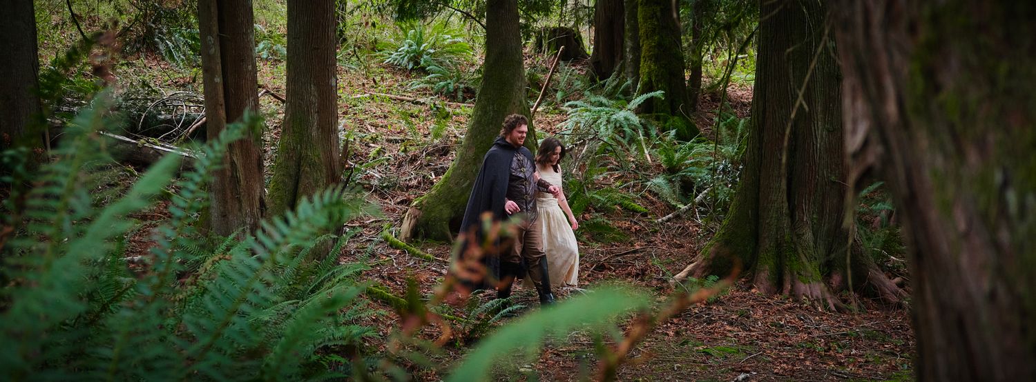 A couple walking through the woods in Washington State. Photo by N&D Wedding Photography and Film