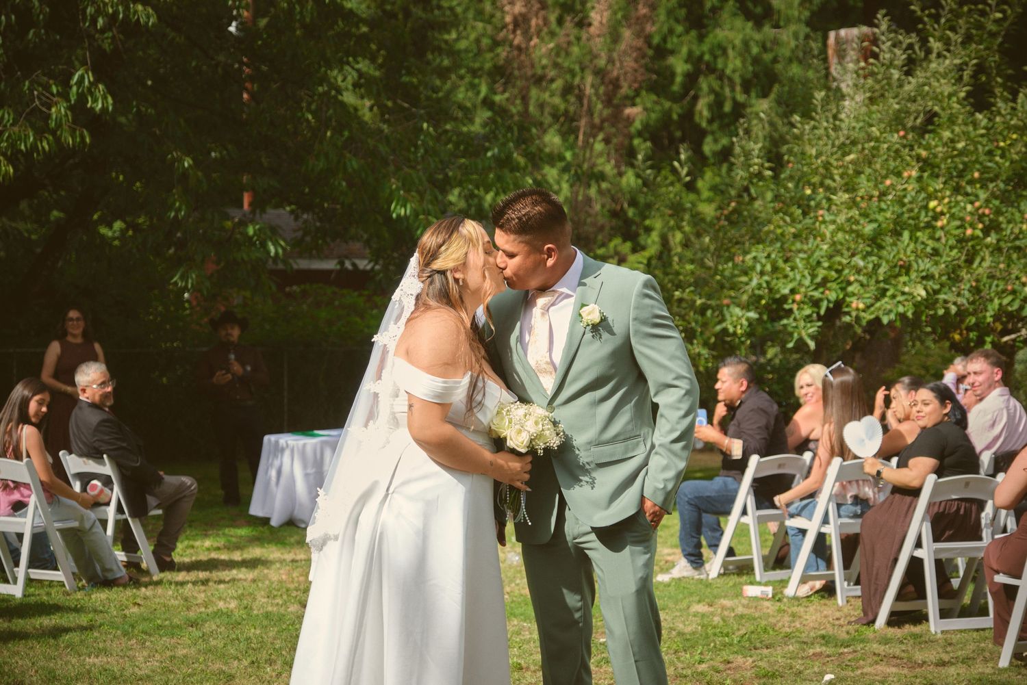 A newly married couple kisses in the middle of the aisle in Tulalip Washington. Photo by N&D Wedding Photography and Film