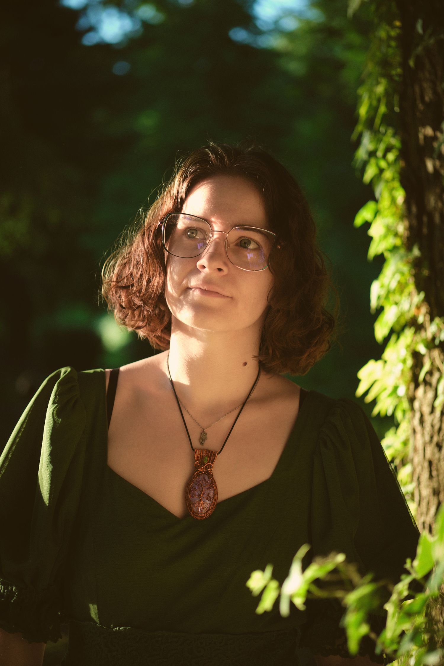 Miranda, owner of Foggé Crystal Company by a tree in a Snohomish County, Washington State forest. Photo by N&D Wedding Photography and Film