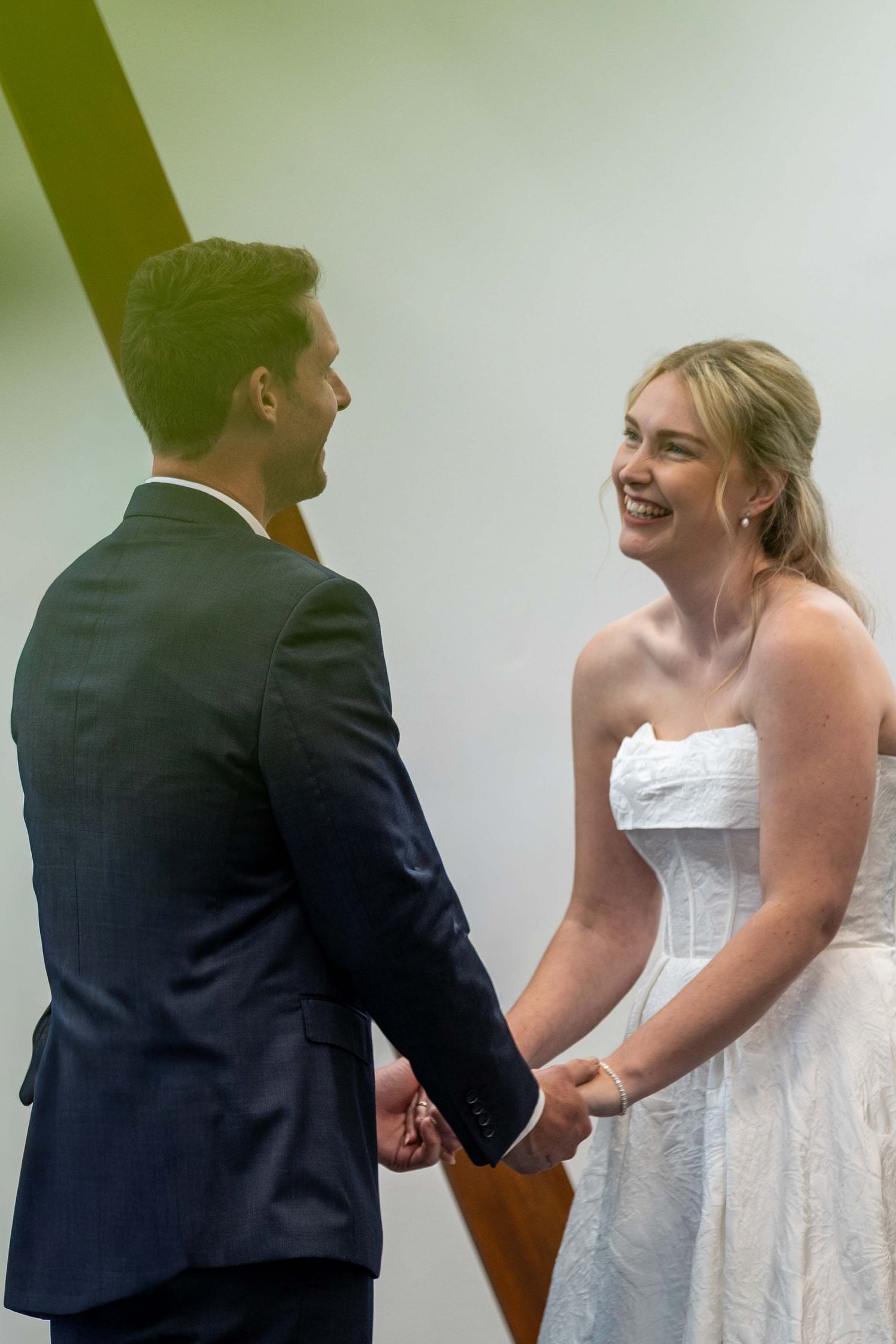 A couple exchanges vows during an intimate indoor wedding ceremony.