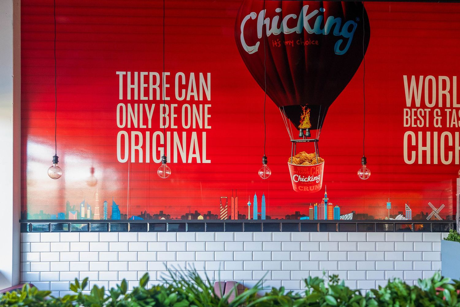 Chicking restaurant wall mural with red background, hot air balloon, and 'There Can Only Be One Original' slogan.