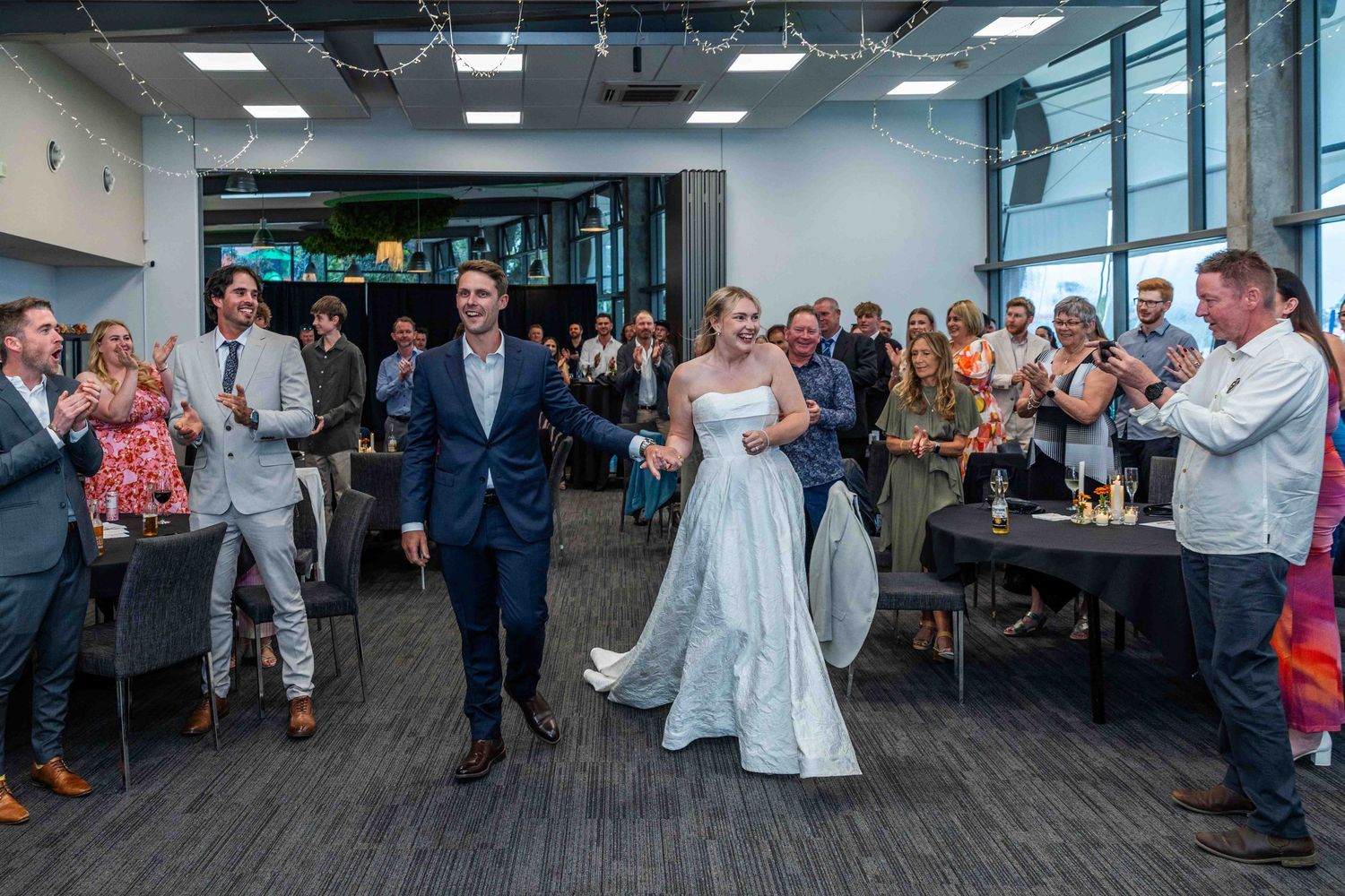 Wedding celebration in modern office space with guests watching.