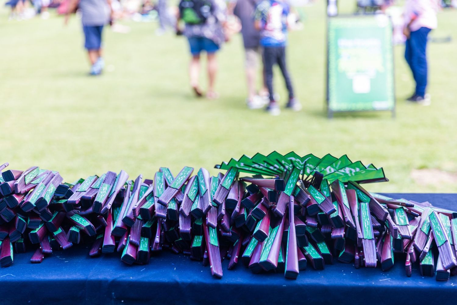 Display of promotional materials and banners at a sunny outdoor venue.