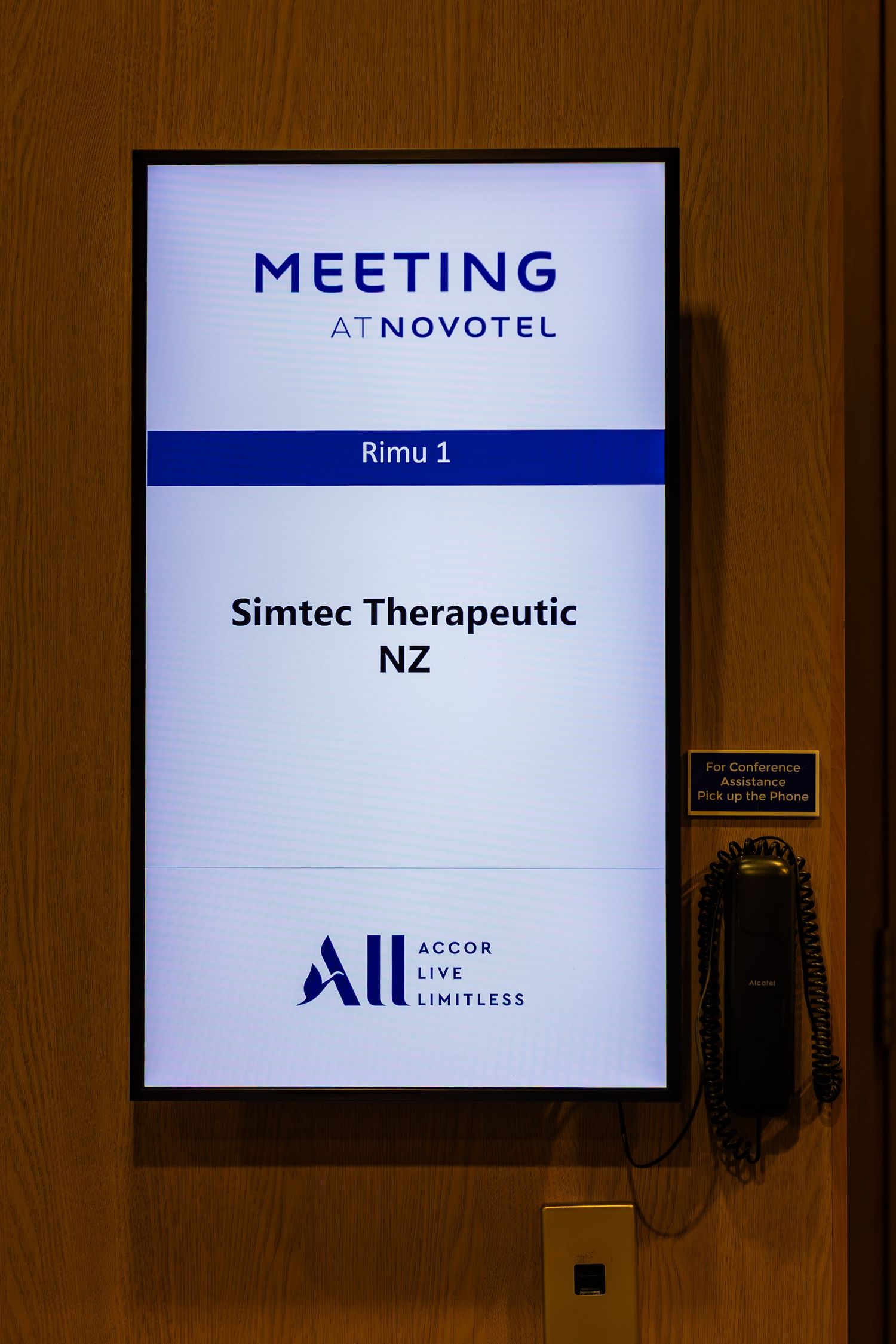 Meeting at Novotel sign displaying Rimu 1 room for Simtec Therapeutic NZ, Accor Live Limitless branding.