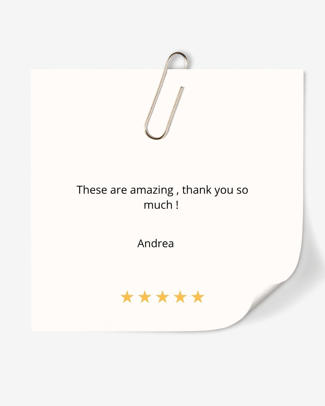 A five-star customer review note from Andrea praising amazing products, displayed on a sticky note with a paper clip.