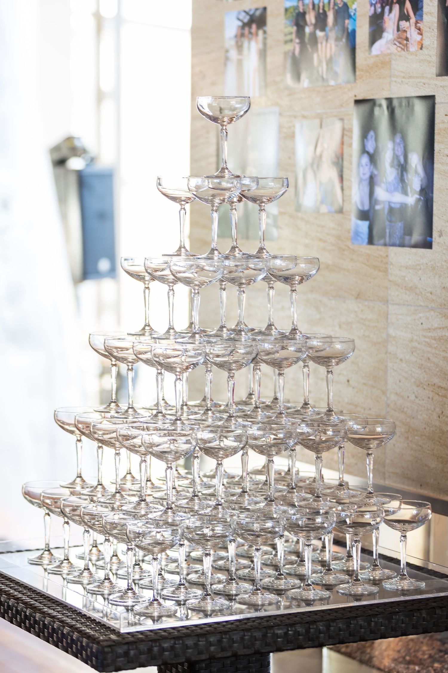 Elegant champagne glass tower pyramid display at a wedding reception venue.