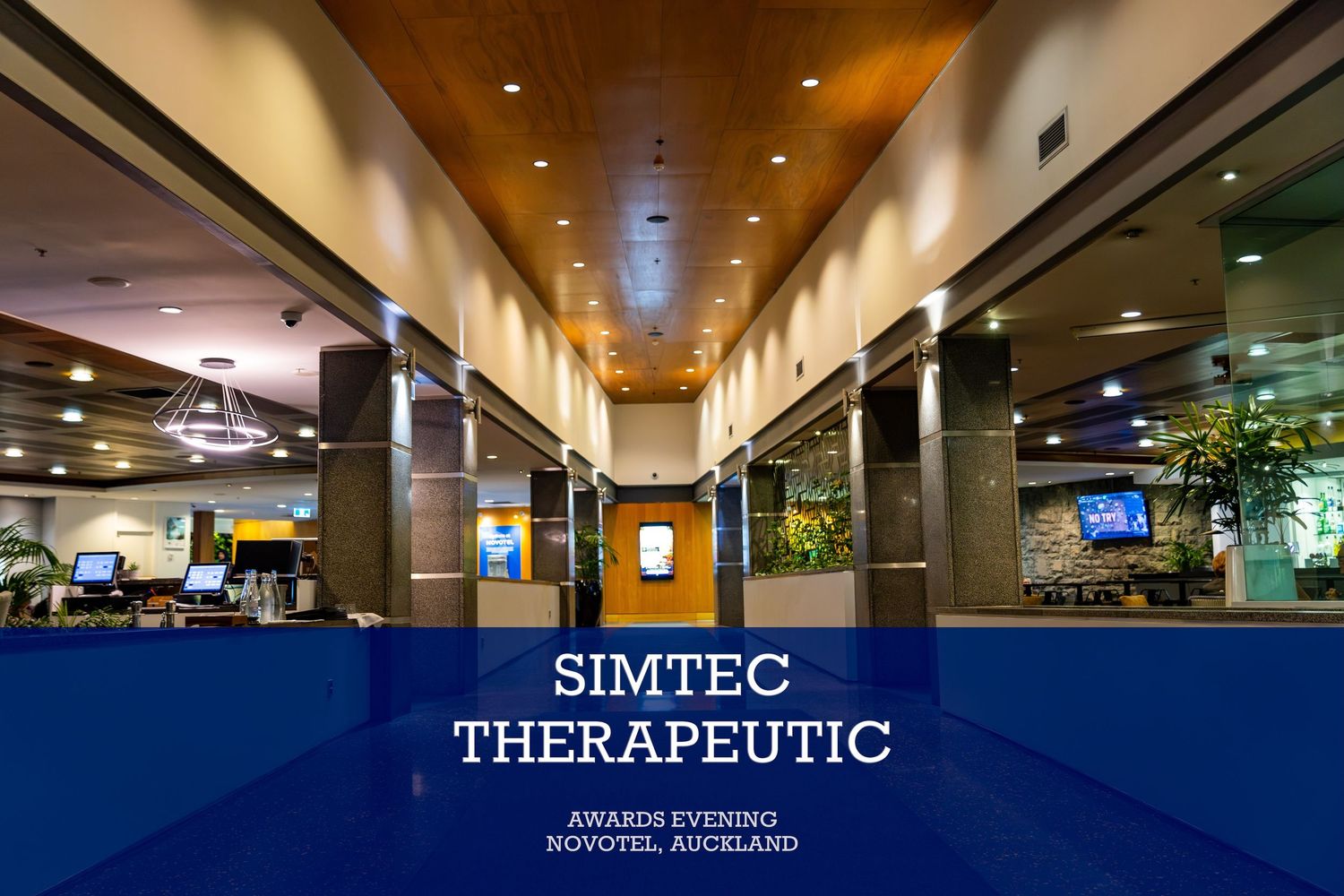 SimTec Therapeutic Awards Evening at Novotel Auckland, featuring an elegant hotel lobby with warm lighting.