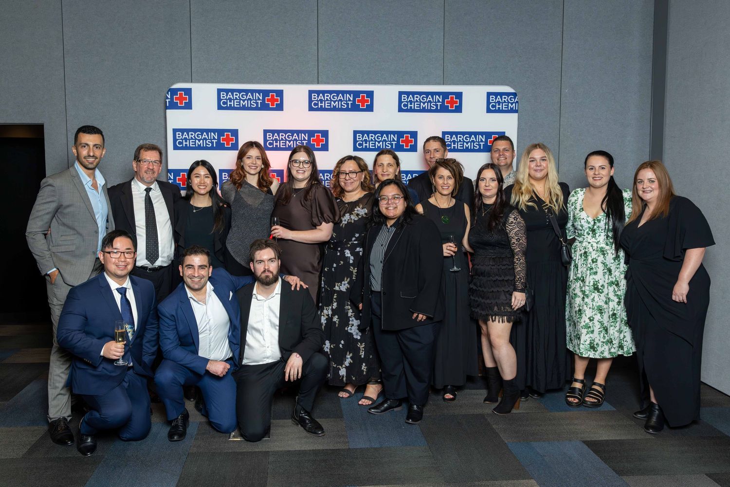 Group photo of business professionals at corporate awards ceremony.